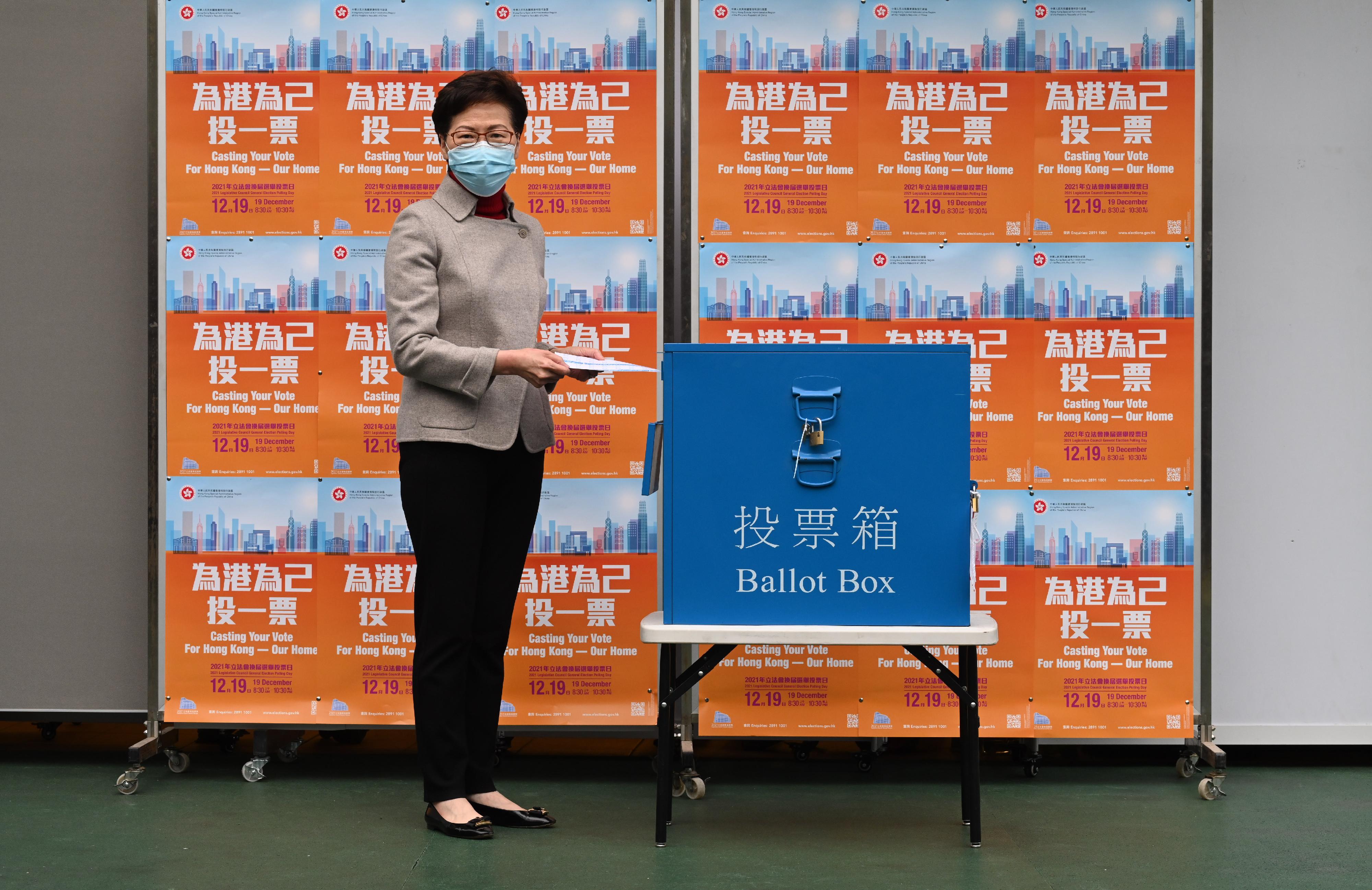 The Chief Executive, Mrs Carrie Lam, cast her vote in the 2021 Legislative Council General Election (LCGE) at Raimondi College this morning (December 19). Picture shows Mrs Lam casting her vote for the geographical constituency in the 2021 LCGE.