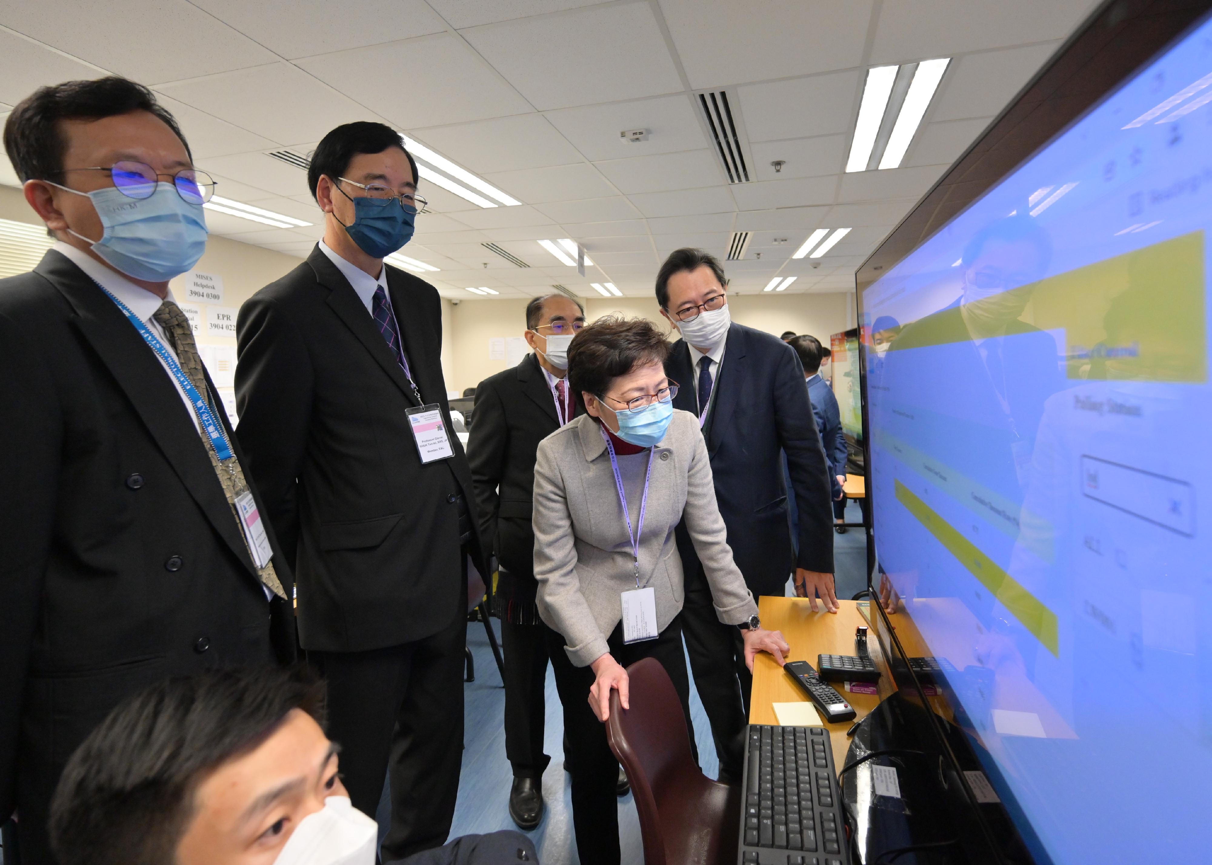 The Chief Executive, Mrs Carrie Lam (second right), accompanied by the Chairman of the Electoral Affairs Commission, Mr Justice Barnabas Fung Wah (first right), visits the Central Command Centre of the 2021 Legislative Council General Election this morning (December 19) to inspect its operation.