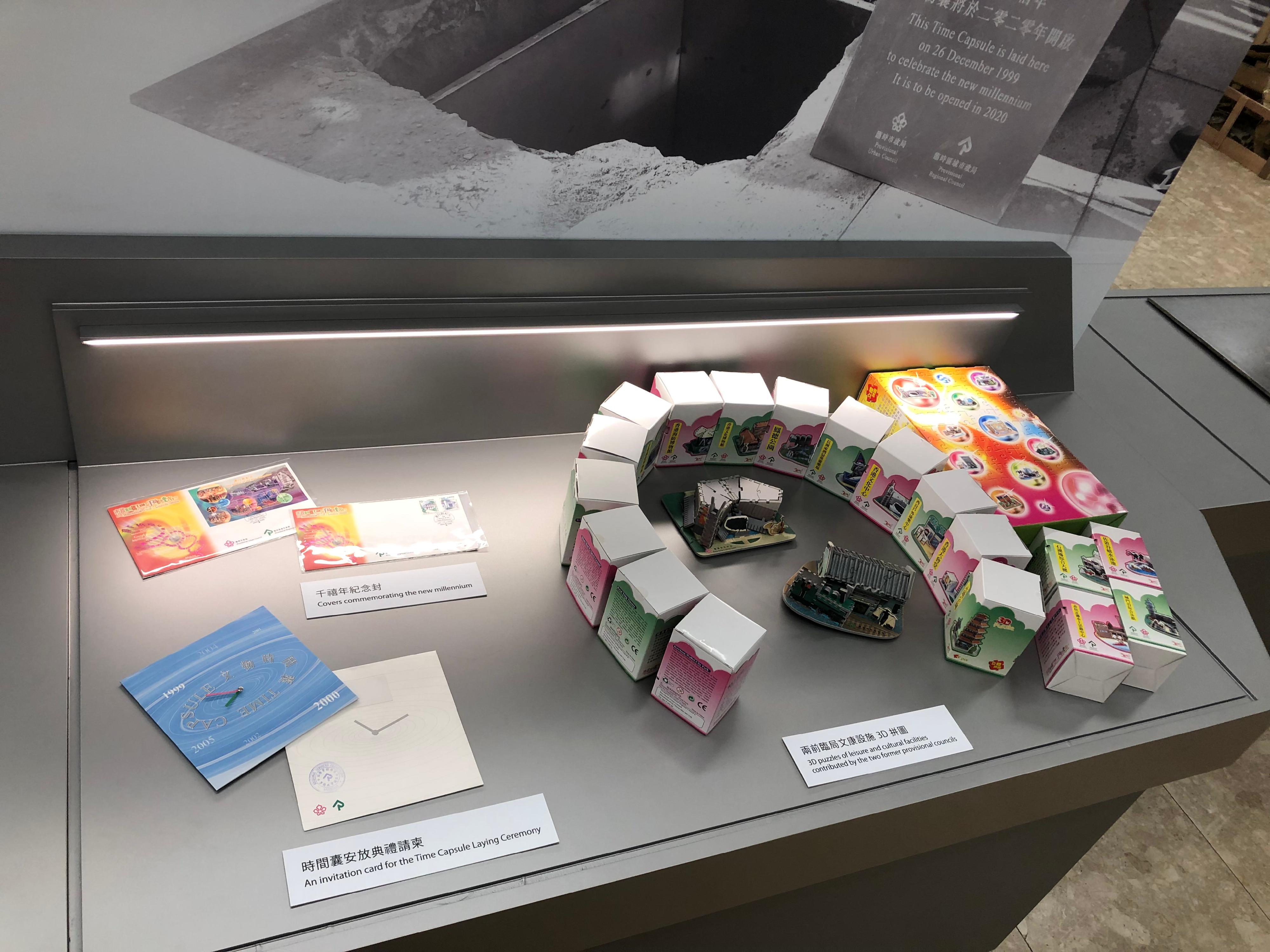 The Leisure and Cultural Services Department today (December 28) started to display at Tsuen Wan Town Hall the time capsule that was buried by the former Provisional Urban Council and the former Provisional Regional Council. Picture shows covers commemorating the new millennium (top left), an invitation card for the Time Capsule Laying Ceremony (bottom left), and the 3D puzzles of the Hong Kong Cultural Centre and the Hong Kong Railway Museum (right).