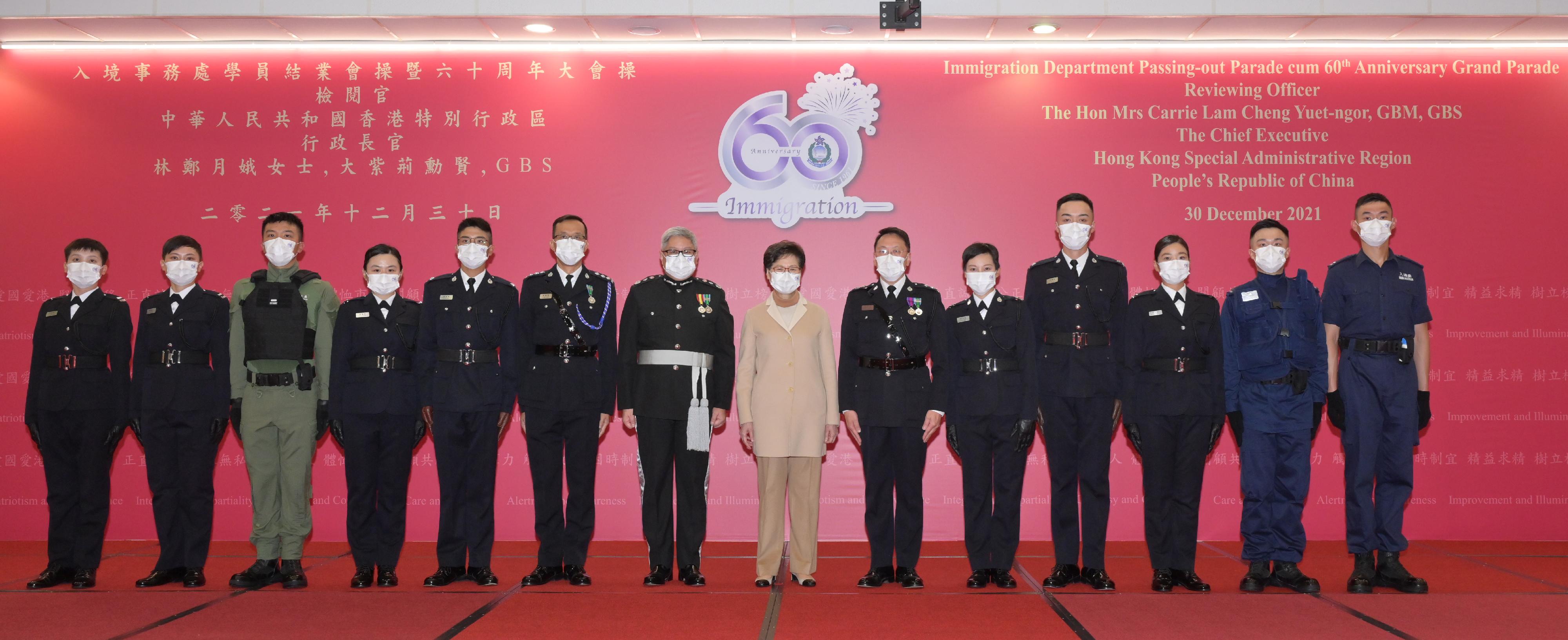 The Chief Executive, Mrs Carrie Lam (seventh right), is pictured with the Director of Immigration, Mr Au Ka-wang (seventh left), as well as graduates awarded with Best Recruit Shields and other guests after the Immigration Department Passing-out Parade cum 60th Anniversary Grand Parade today (December 30).