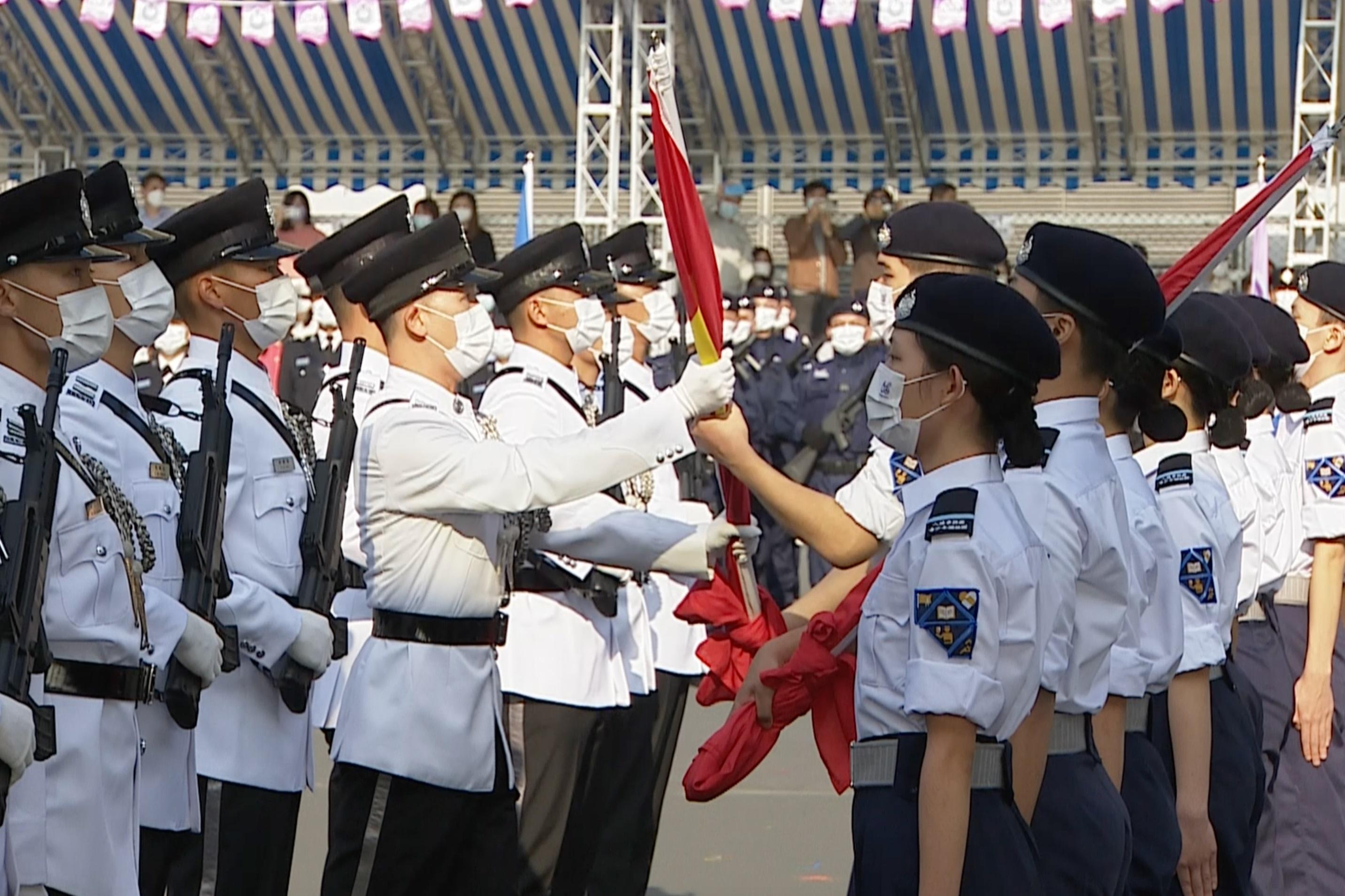 Members of the Immigration Department Youth Leaders Corps hand over the national, regional and departmental flags to the Flag Party at the Immigration Department Passing-out Parade cum 60th Anniversary Grand Parade today (December 30).