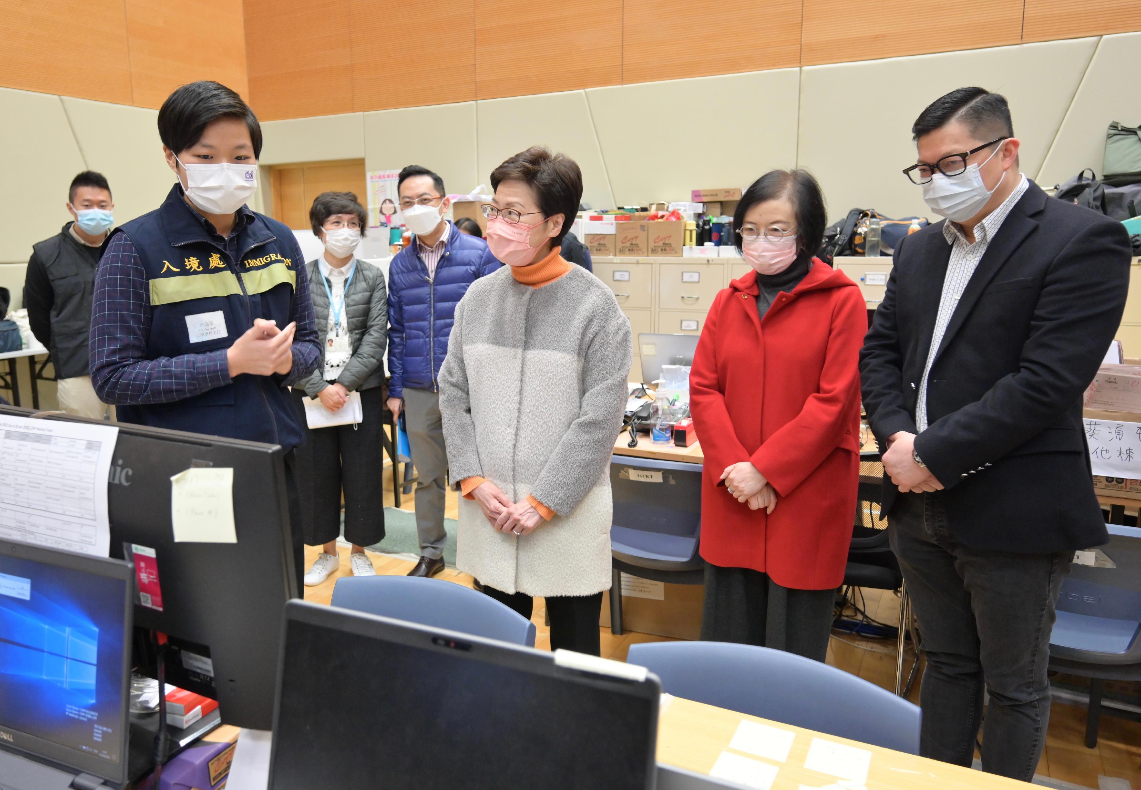 The Chief Executive, Mrs Carrie Lam, visited the Contact Tracing Offices in Kai Tak and Mong Kok today (February 1). Photo shows Mrs Lam (third right) being briefed by an immigration officer on the work of the Contact Tracing Office in Kai Tak. Looking on are the Secretary for Food and Health, Professor Sophia Chan (second right), and the Secretary for Security, Mr Tang Ping-keung (first right).