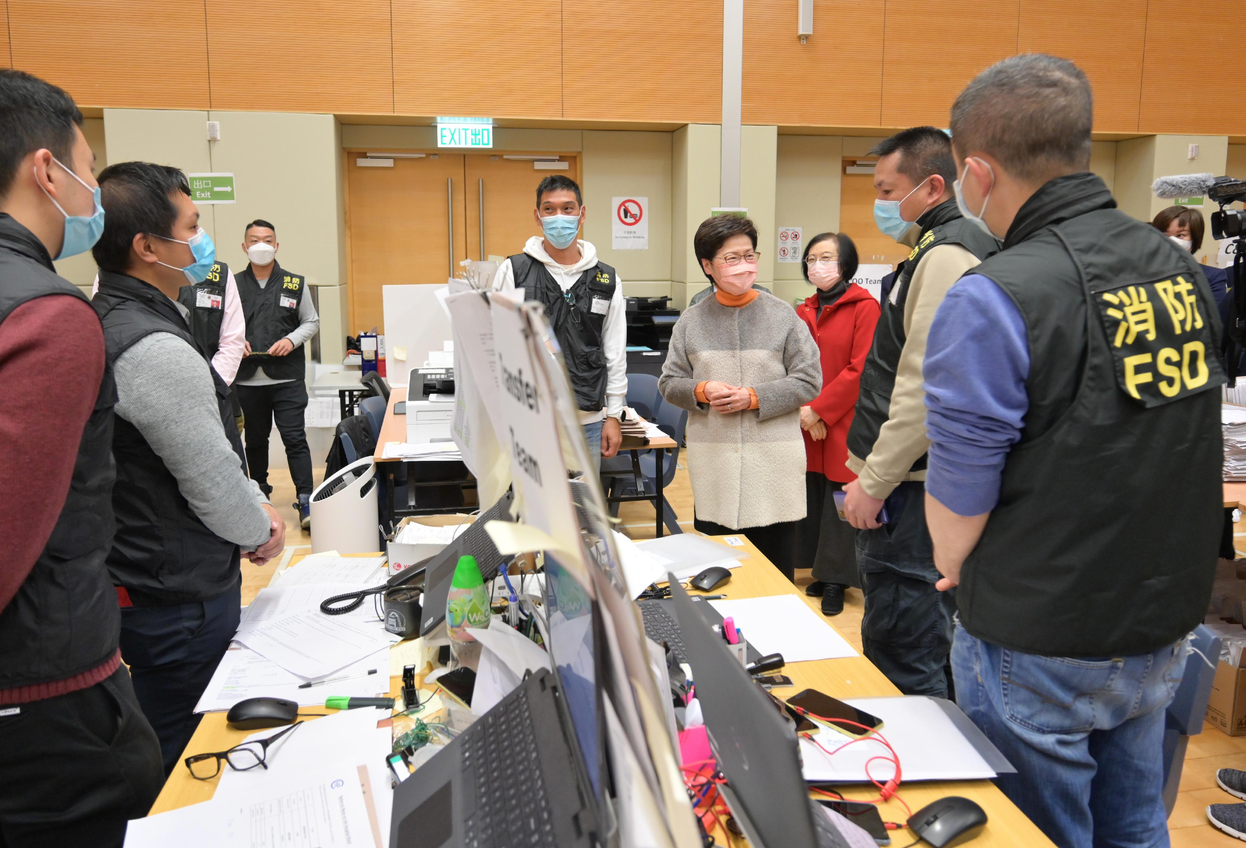 The Chief Executive, Mrs Carrie Lam, visited the Contact Tracing Offices in Kai Tak and Mong Kok today (February 1). Photo shows Mrs Lam (fourth right) chatting with officers of the Fire Services Department at the Contact Tracing Office in Kai Tak. Looking on is the Secretary for Food and Health, Professor Sophia Chan (third right).