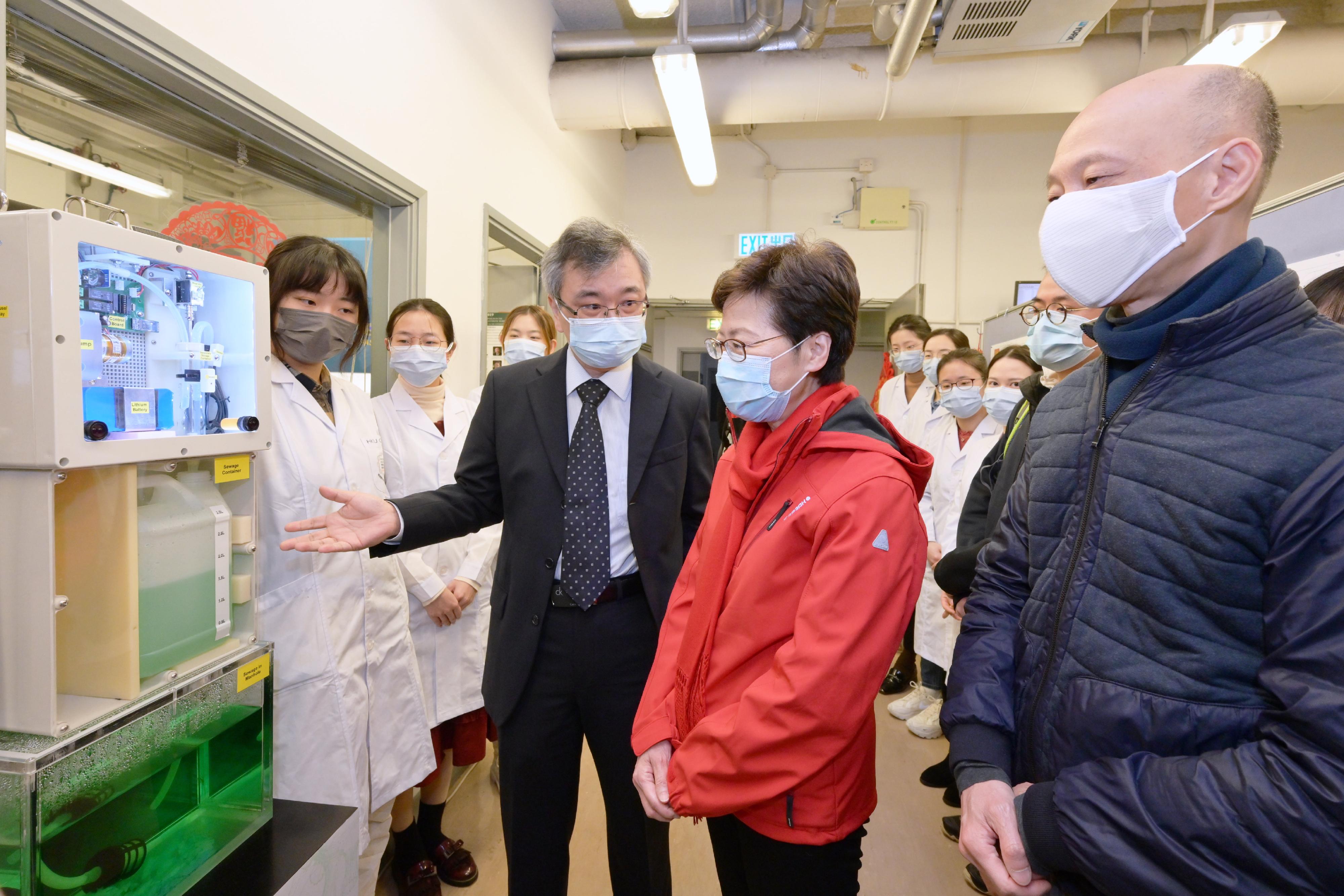 The Chief Executive, Mrs Carrie Lam, visited the Environmental Microbiome Engineering and Biotechnology Laboratory of the University of Hong Kong today (February 2). Photo shows Mrs Lam (second right), accompanied by the Secretary for the Environment, Mr Wong Kam-sing (first right), being briefed by Professor Zhang Tong (third right) of the laboratory, on the treatment of sewage samples and testing process.