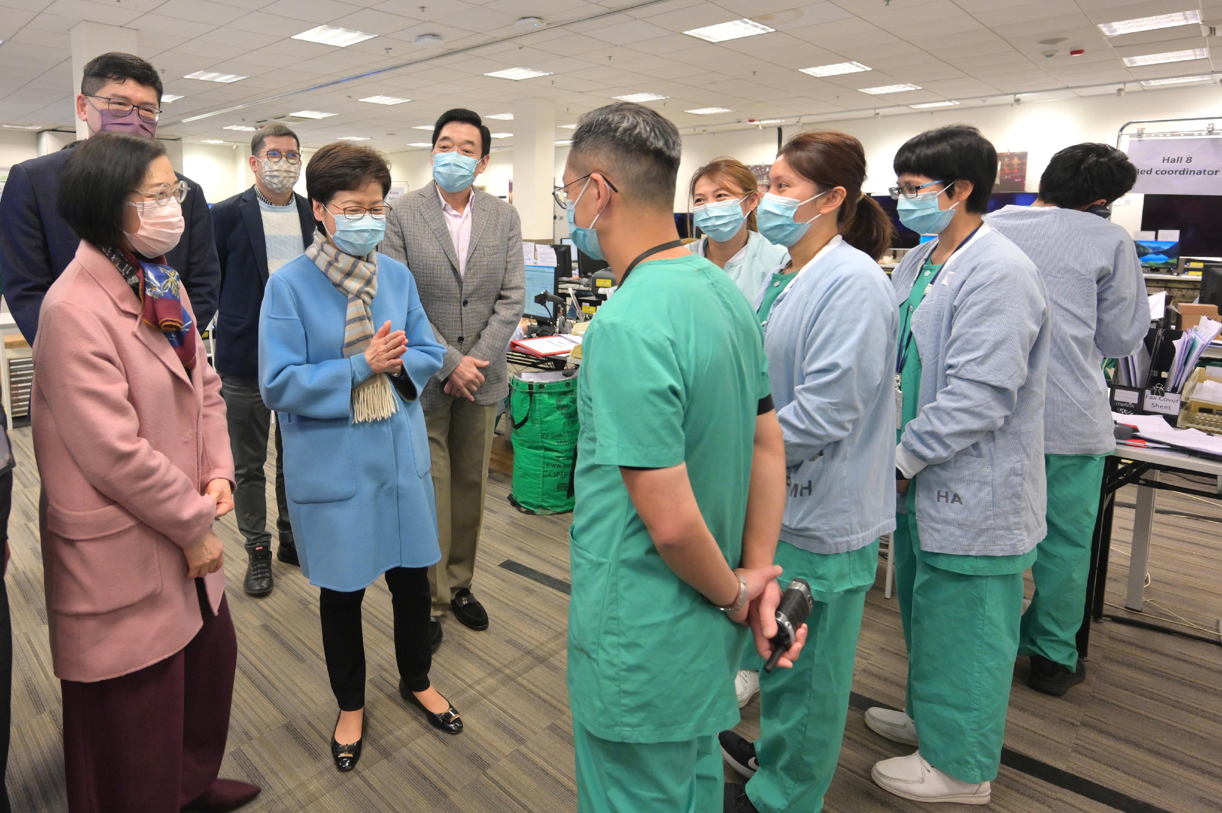 The Chief Executive, Mrs Carrie Lam, visited the community treatment facility at Asia-World Expo today (February 3). Photo shows Mrs Lam (fourth left) chatting with the medical staff. Looking on are the Secretary for Food and Health, Professor Sophia Chan (first left); the Chairman of the Hospital Authority, Mr Henry Fan (fifth left); and the Chief Executive of the Hospital Authority, Dr Tony Ko (second left).