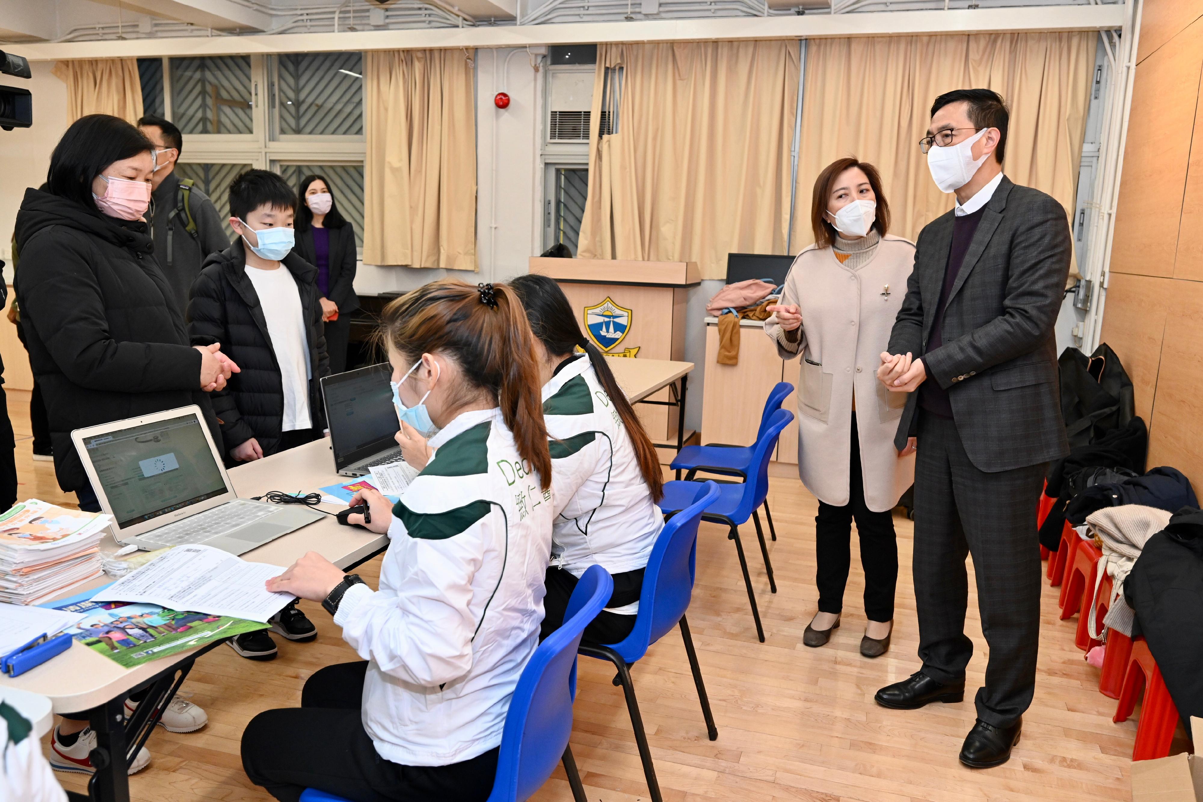 The Secretary for Education, Mr Kevin Yeung, visited Shau Kei Wan Government Primary School today (February 25) to inspect the implementation of the Vaccination Subsidy Scheme School Outreach. Picture shows Mr Yeung (first right) being briefed by the Headmistress, Ms Leung Ching-yee (second right), on the arrangements.