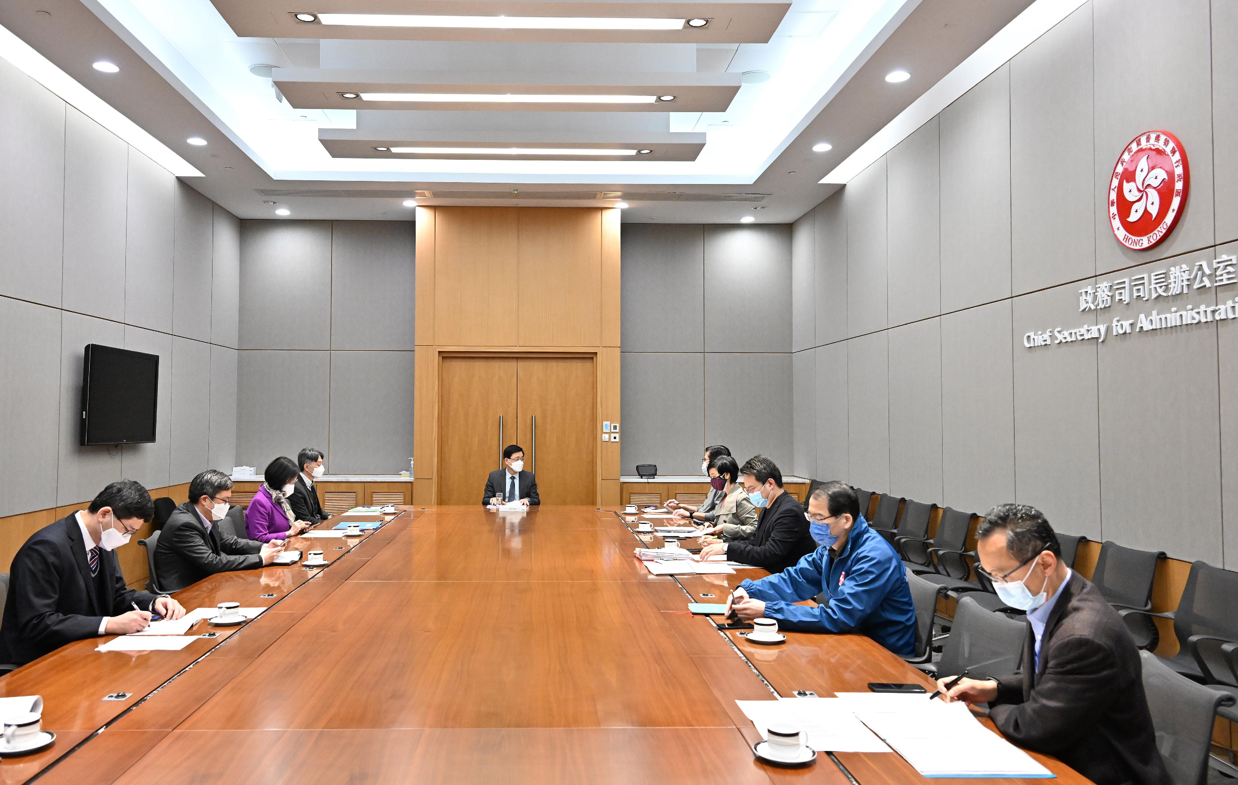 The Chief Secretary for Administration, Mr John Lee, held meetings today (February 28) on the commencement of the Tsing Yi community isolation facility. Photo shows Mr Lee (centre) chairing an inter-departmental meeting and receiving briefings from relevant bureaux and departments on the preparatory works for the commencement of the Tsing Yi community isolation facility.
