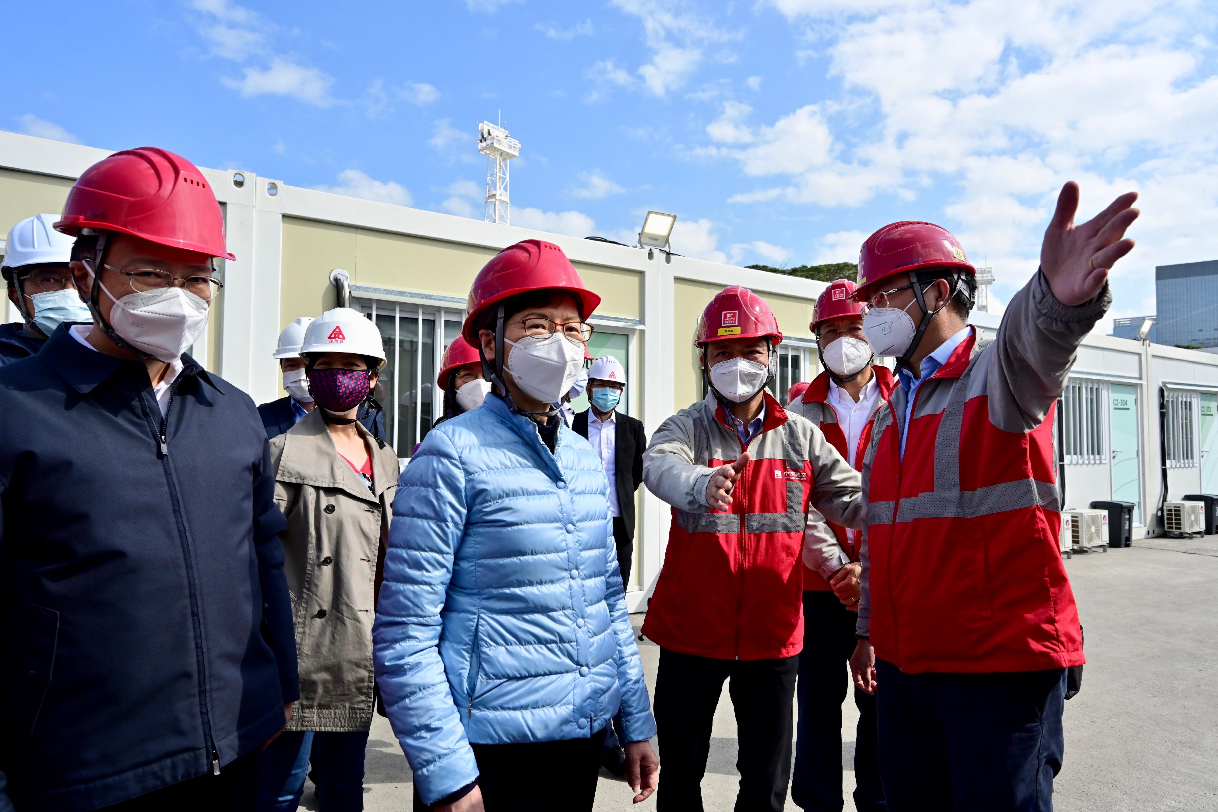 The Chief Executive, Mrs Carrie Lam, today (February 28) visited the community isolation facilities constructed with Mainland support at Tsing Yi. Photo shows Mrs Lam (front, second left), accompanied by the Chairman and Non-executive Director of the China State Construction International Holdings Limited, Mr Yan Jianguo (front, second right), receiving a briefing from a staff member of the contractor on the facilities. Looking on is the Deputy Director of the Liaison Office of the Central People's Government in the Hong Kong Special Administrative Region, Mr Chen Dong (front, first left).
 
