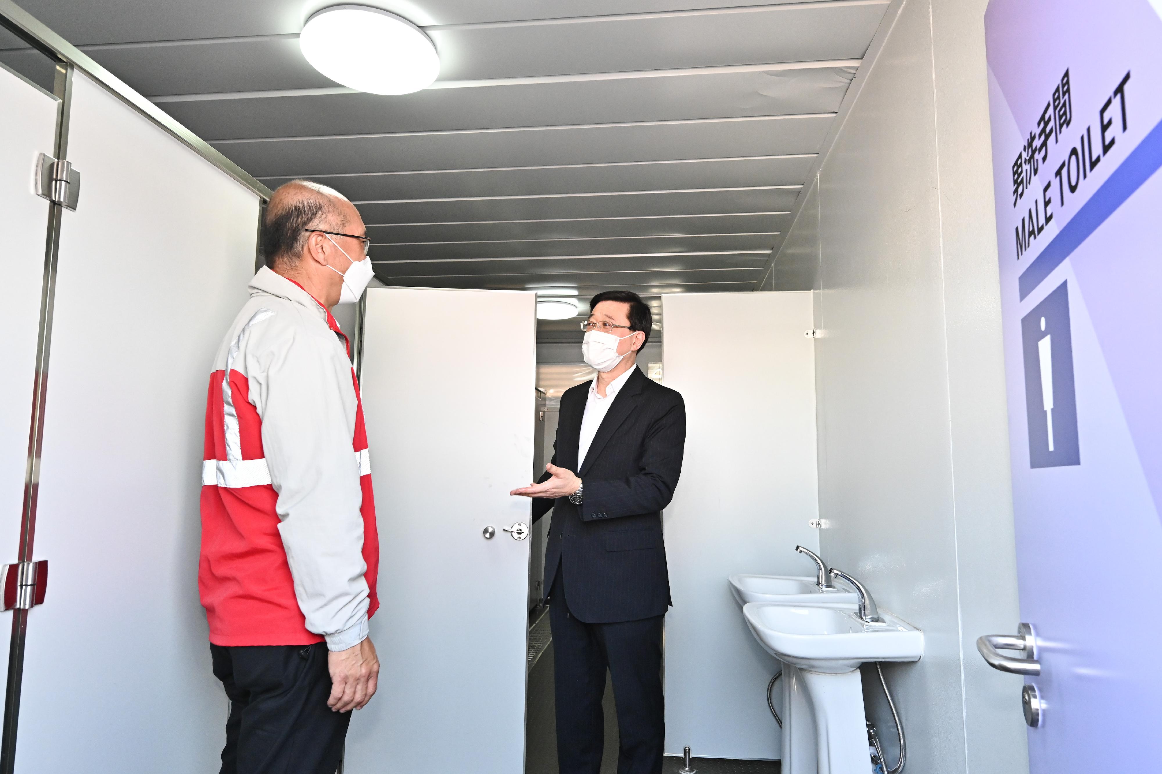 The Chief Secretary for Administration, Mr John Lee, this morning (March 12) visited the third community isolation facility constructed with Mainland support on the Hong Kong Boundary Crossing Facilities Island of the Hong Kong-Zhuhai-Macao Bridge. Photo shows Mr Lee (right), accompanied by a representative of the contractor, viewing the newly constructed facilities.