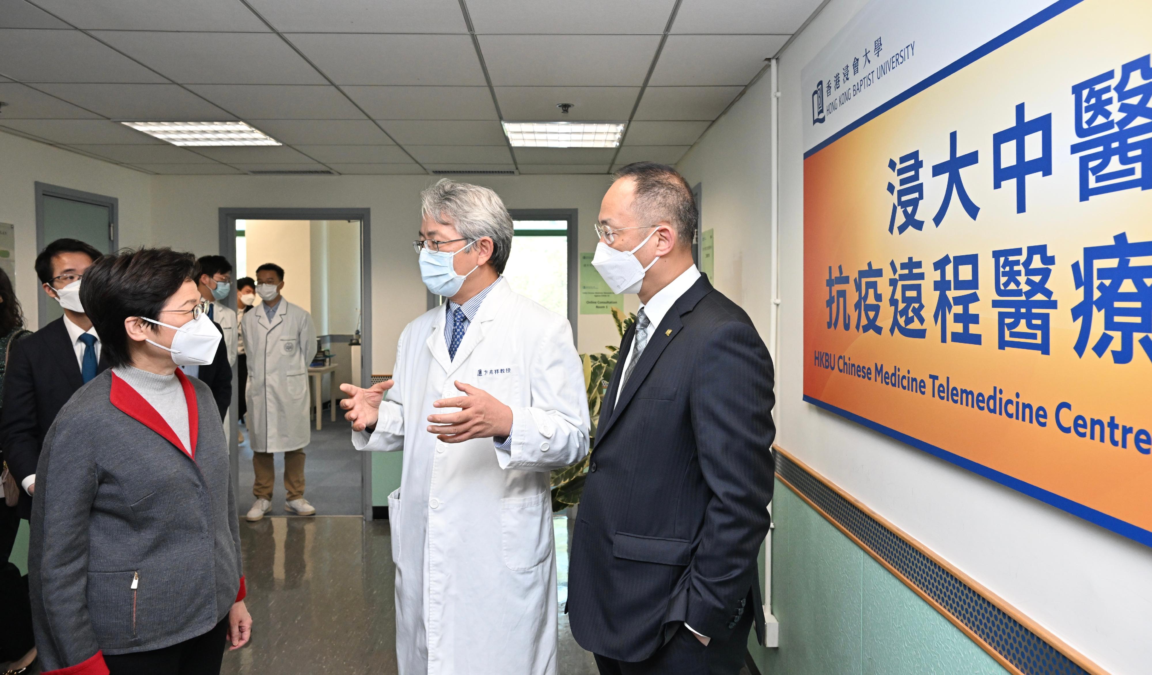 The Chief Executive, Mrs Carrie Lam, visited the Chinese Medicine Telemedicine Centre Against COVID-19 of the Hong Kong Baptist University (HKBU) today (March 12). Photo shows Mrs Lam (first left) being briefed by the President and Vice-Chancellor of HKBU, Professor Alexander Wai (first right) and the Associate Vice-President (Chinese Medicine Development) and Director of the Clinical Division of the School of Chinese Medicine of HKBU, Professor Bian Zhaoxiang (second right) on the Centre's service.