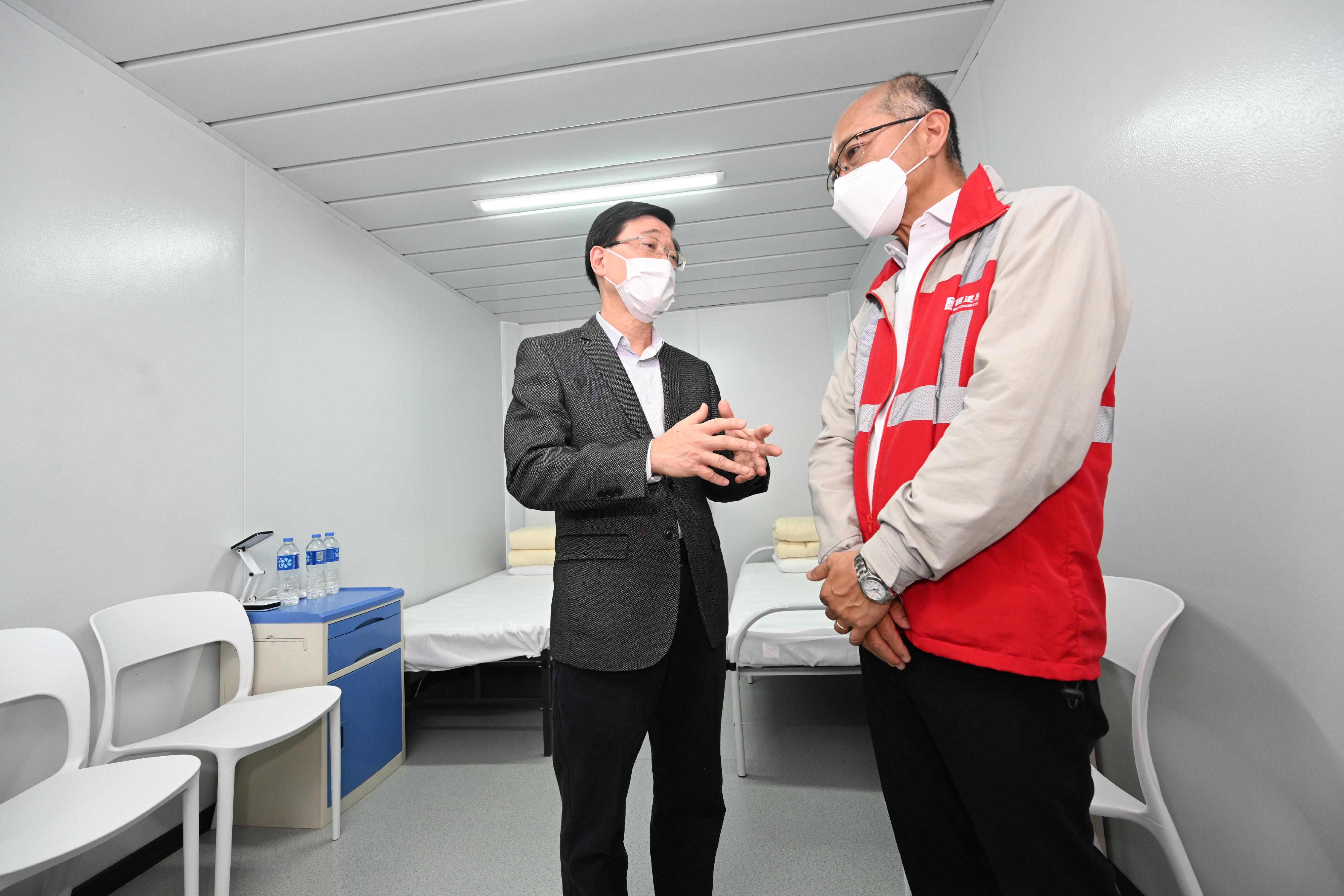 The Chief Secretary for Administration, Mr John Lee, this morning (March 13) visited the fourth community isolation facility constructed with Mainland support at Ma Sik Road, Fanling. Photo shows Mr Lee (left), accompanied by a representative of the contractor, touring a newly constructed unit.