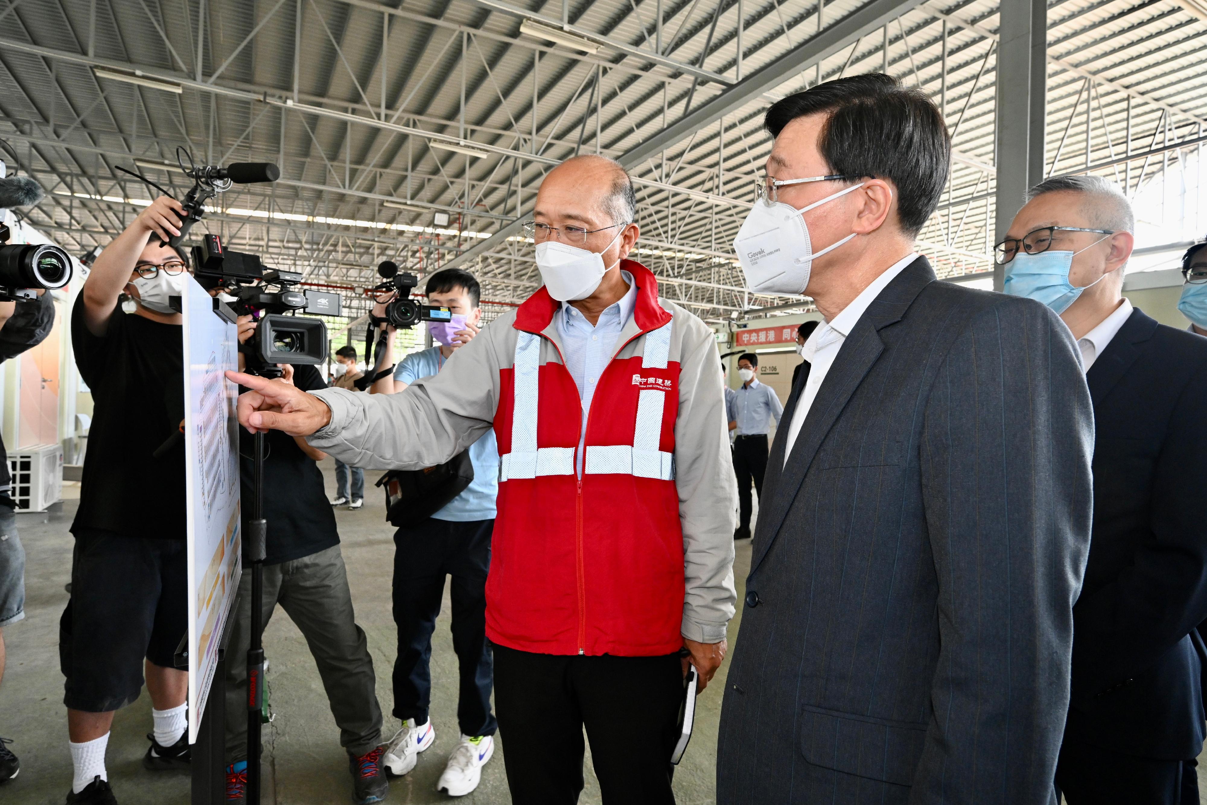 The Chief Secretary for Administration, Mr John Lee, this morning (March 17) visited the fifth community isolation facility constructed with Mainland support near Kai Pak Ling Road at Hung Shui Kiu in Yuen Long. Photo shows Mr Lee (second right) receiving a briefing on the facility from a representative of the contractor. Looking on is the Under Secretary for Food and Health, Dr Chui Tak-yi (first right).