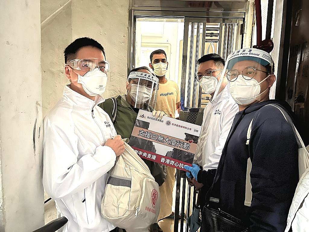 The District Officer (Yau Tsim Mong), Mr Edward Yu (first left), together with representatives from Hong Kong Panyu Clan Federation Limited, visited buildings without management bodies and distributed COVID-19 rapid test kits, anti-epidemic supplies provided by the Central Government, surgical masks, food and cleaning products to households (including ethnic minorities) today (March 23).