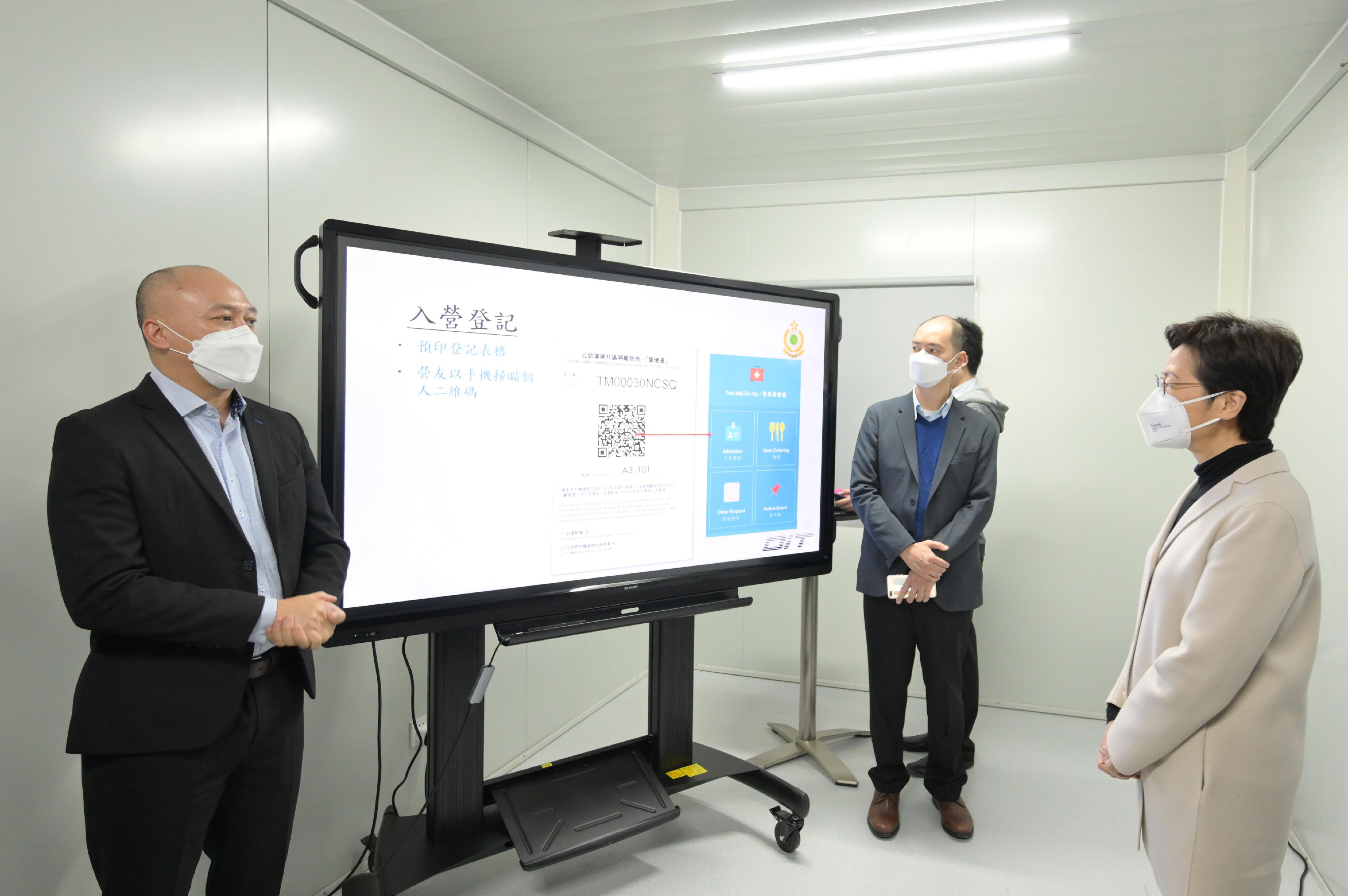 The Chief Executive, Mrs Carrie Lam, this afternoon (March 24) visited the sixth community isolation facility constructed with Mainland support in Yuen Long. Photo shows Mrs Lam (right) receiving a briefing on the newly added Co-Op Platform.