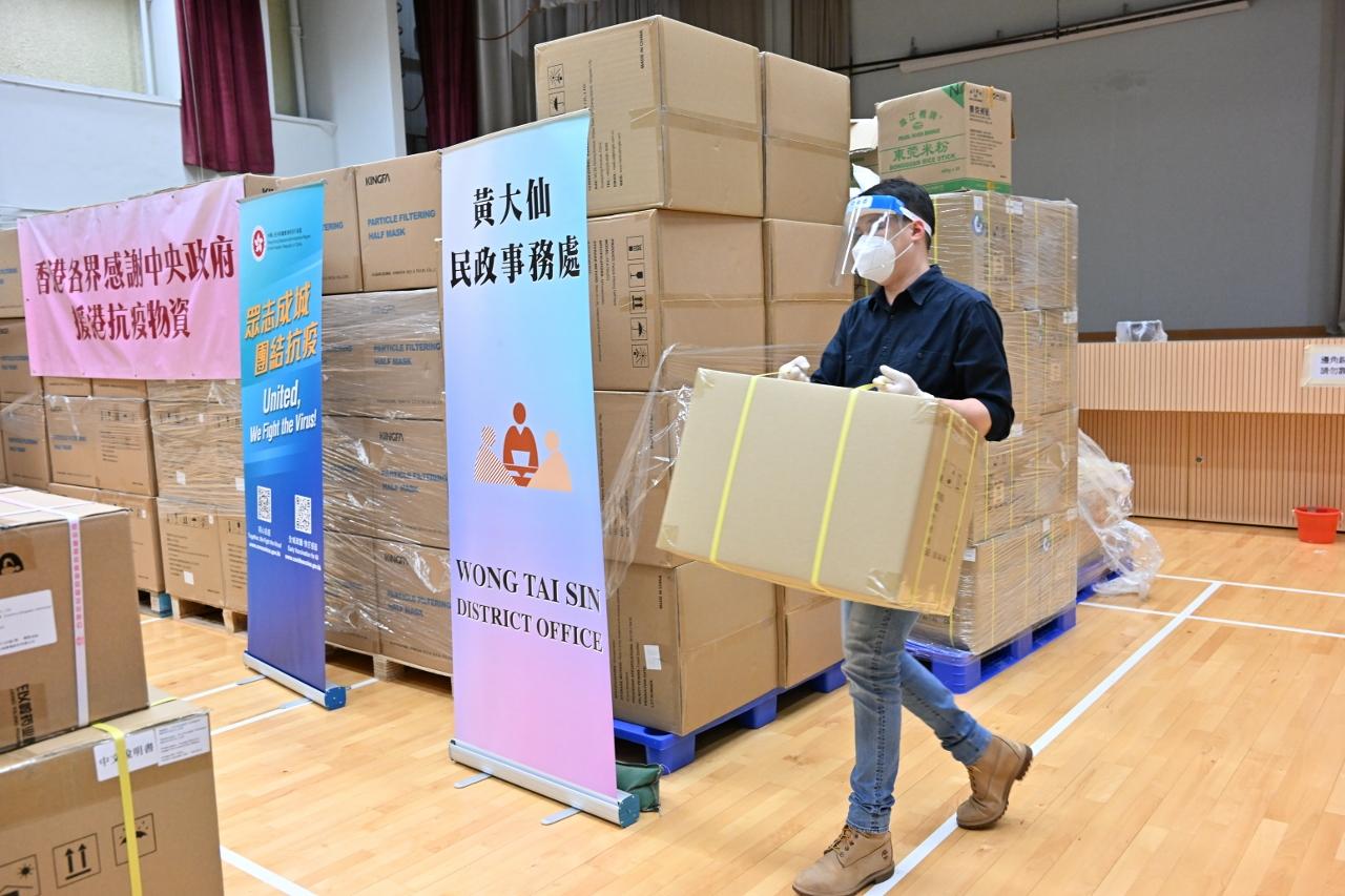 The Special Administrative Region Government is working at full steam on the preparation of packaging and distribution of anti-epidemic service bags. Photo shows staff member organising anti-epidemic supplies at the distribution centre.