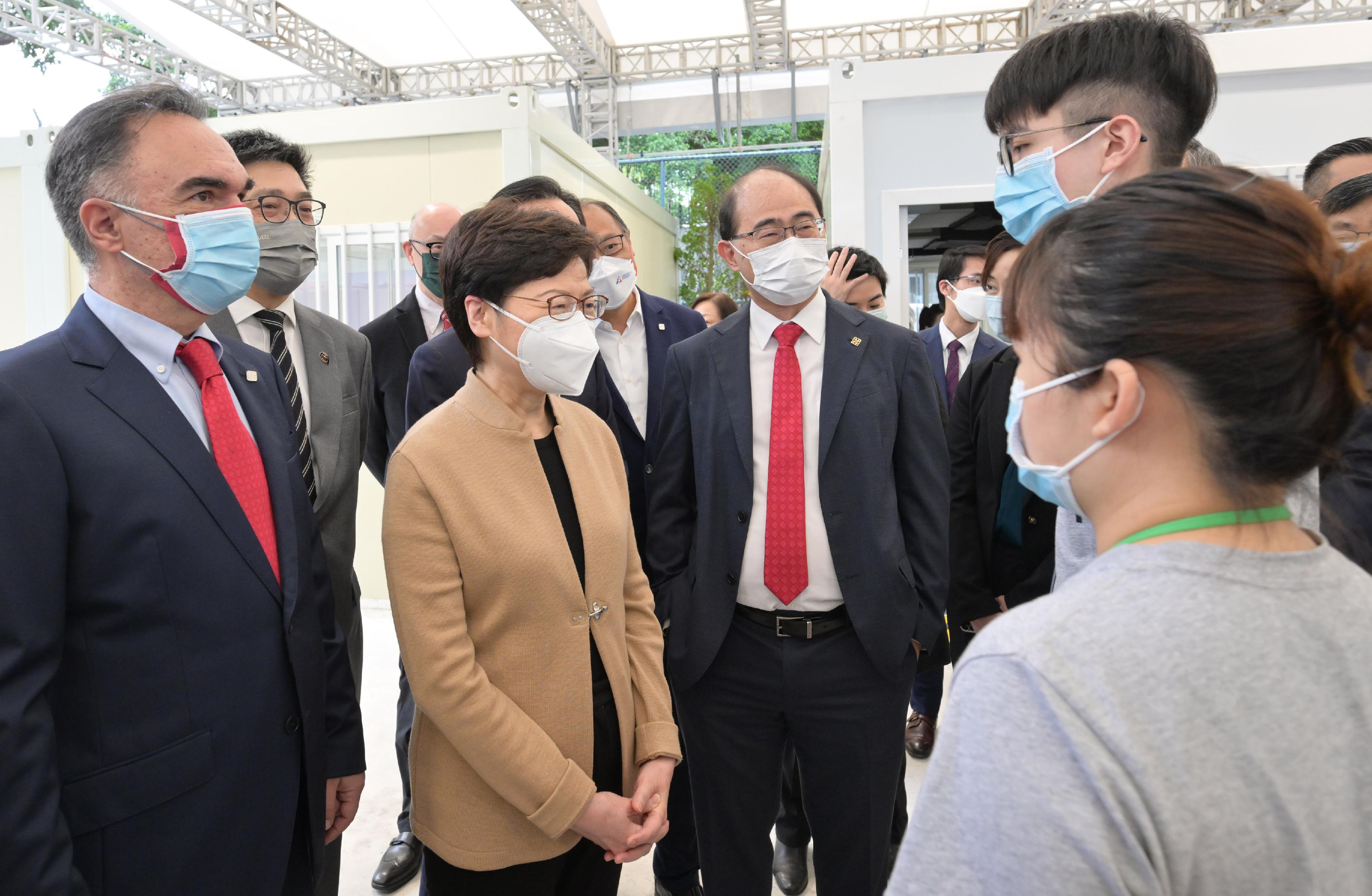 The Chief Executive, Mrs Carrie Lam, visited the Caroline Hill Road Pop-up Community Vaccination Centre today (March 29). Photo shows Mrs Lam (third left) chatting with staff at the centre.