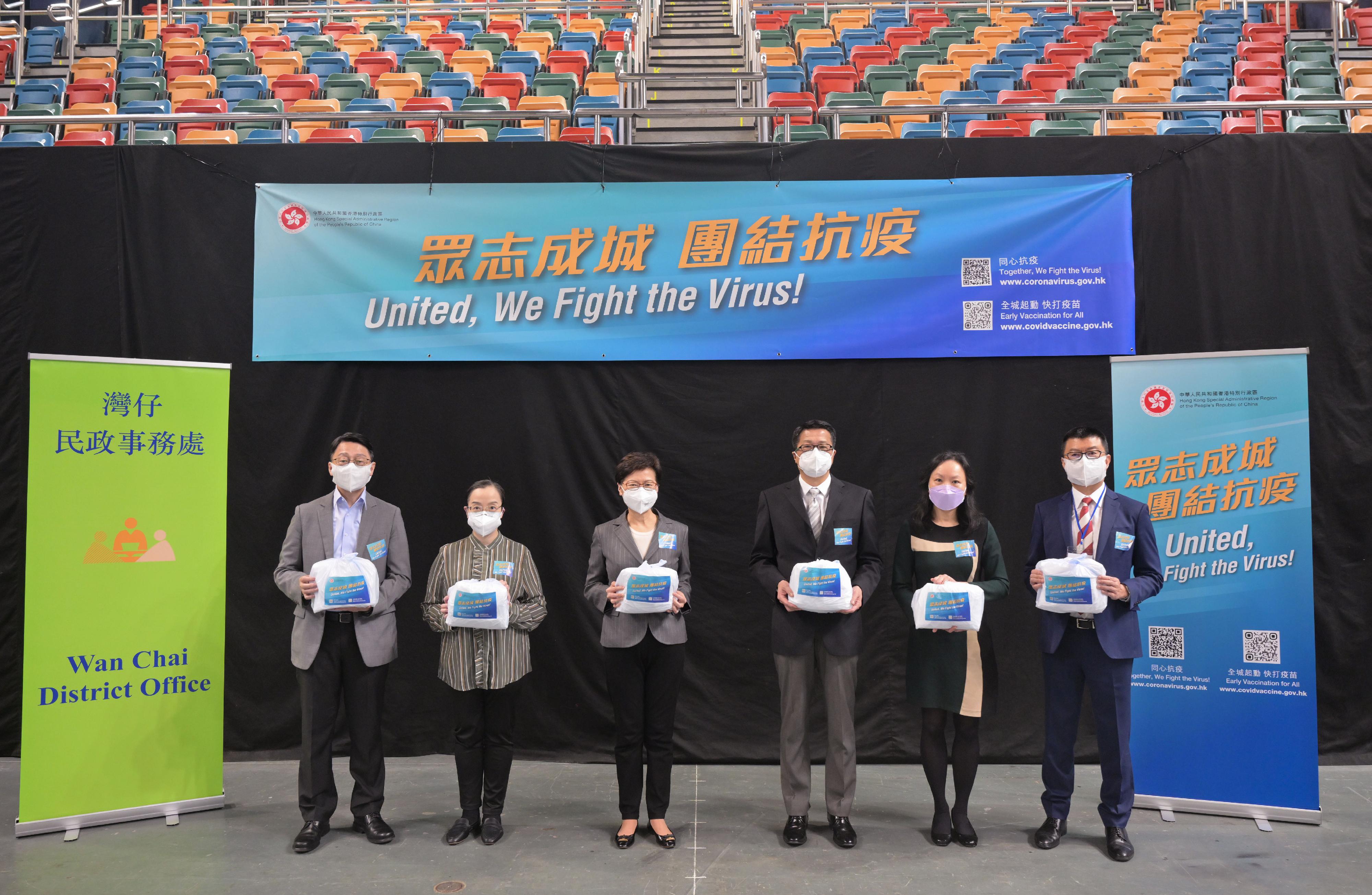 The Chief Executive, Mrs Carrie Lam, today (March 30) visited the packaging centre for anti-epidemic service bags at Queen Elizabeth Stadium in Wan Chai. Photo shows (from left) the Director of Leisure and Cultural Services, Mr Vincent Liu; the Acting Director of Home Affairs, Miss Vega Wong; Mrs Lam; the Acting Secretary for Home Affairs, Mr Jack Chan; the Acting Director of Information Services, Ms Grace Ng; and the District Officer (Wan Chai), Mr Rick Chan, at the centre.