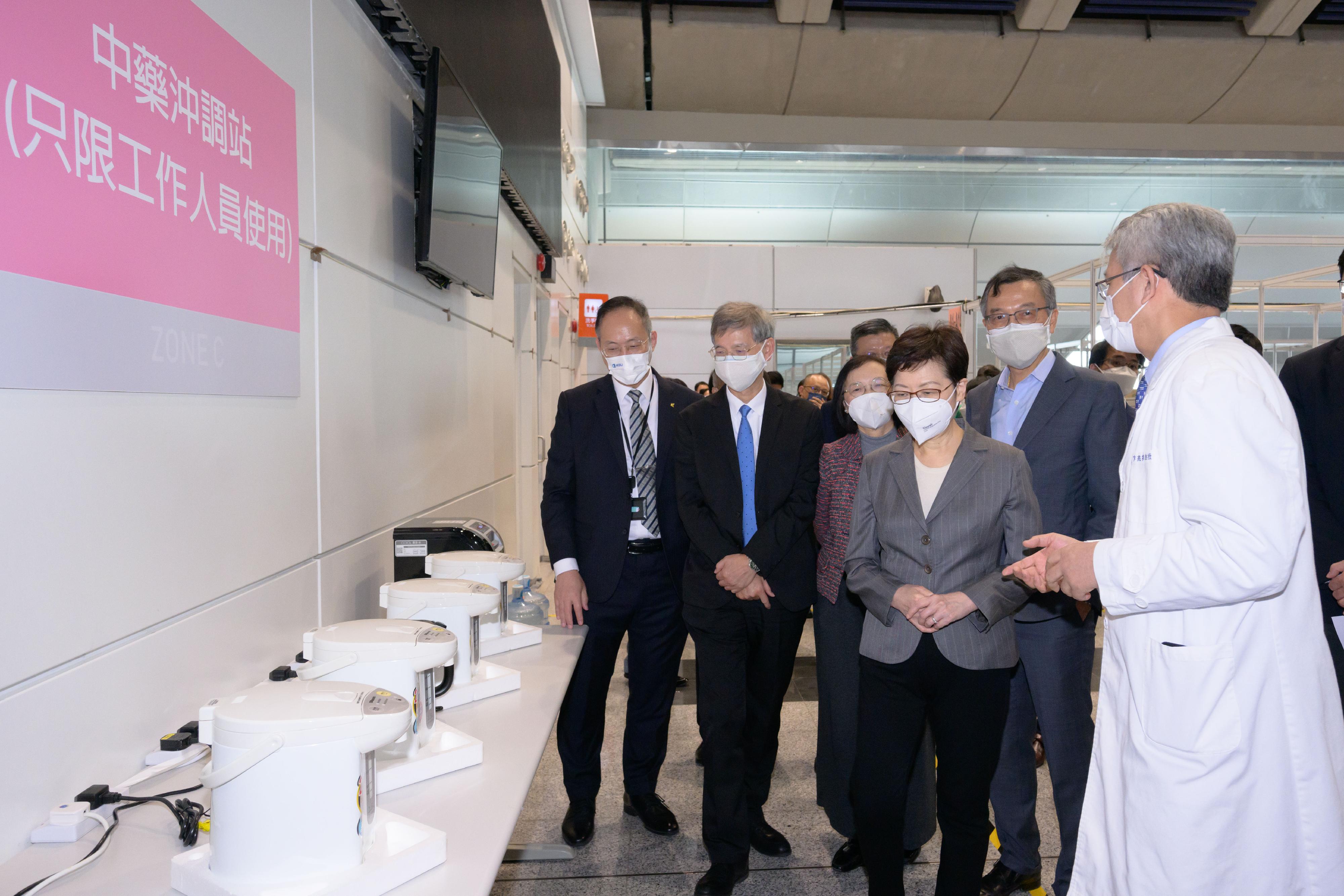 The Chief Executive, Mrs Carrie Lam, visited the Kai Tak Holding Centre today (March 30). Photo shows Mrs Lam (third right) being briefed by the Associate Vice-President (Chinese Medicine Development) of Hong Kong Baptist University (HKBU), Professor Bian Zhaoxiang (first right), on the facilities of the centre. Looking on are the Secretary for Labour and Welfare, Dr Law Chi-kwong (second left); the Secretary for Food and Health, Professor Sophia Chan (third left); the President and Vice-Chancellor of HKBU, Professor Alexander Wai (first left); and the Chief Executive Officer of Haven of Hope Christian Service, Dr Lam Ching-choi (second right).