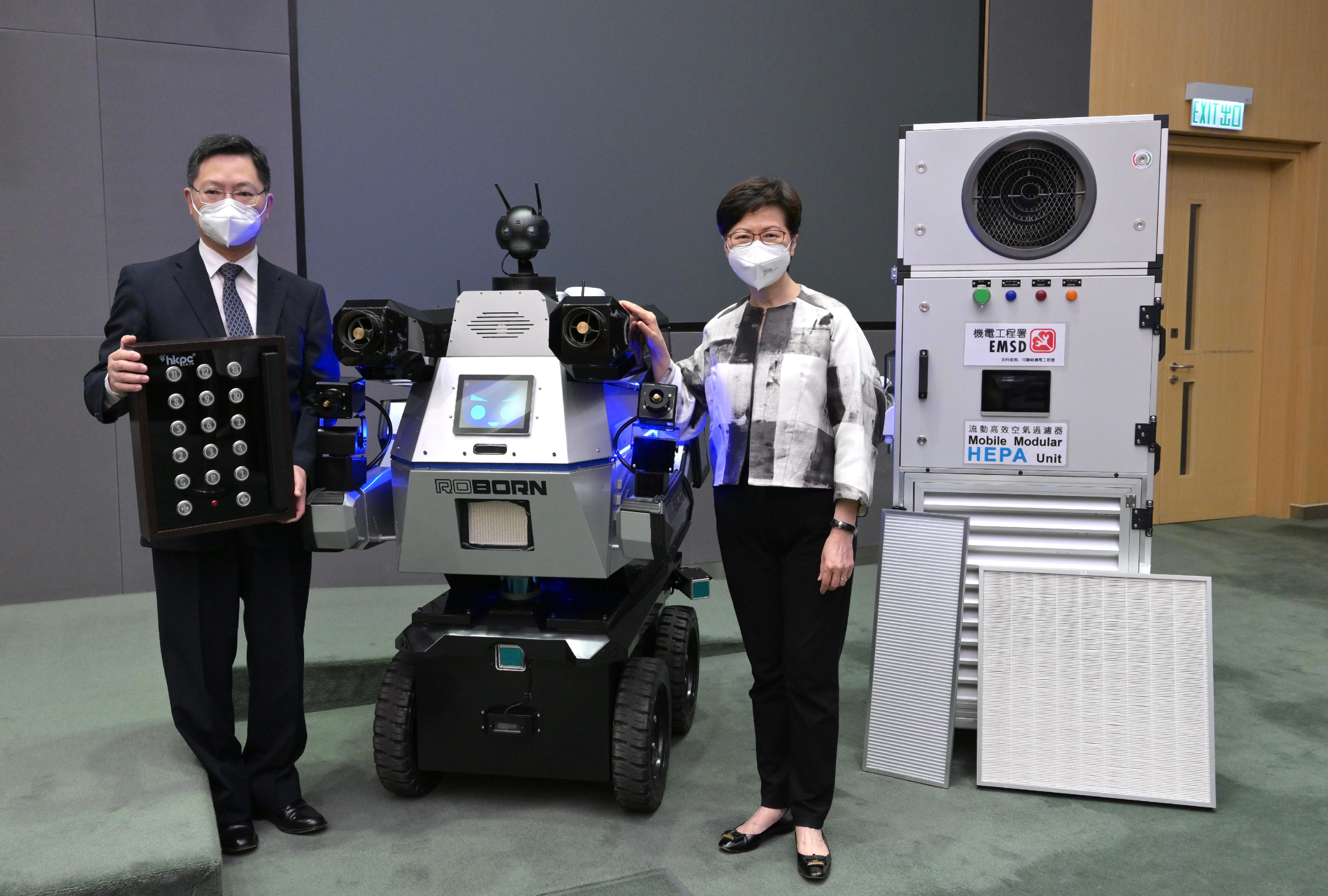 The Chief Executive, Mrs Carrie Lam (right), holds a press conference on measures to fight COVID-19 with the Secretary for Innovation and Technology, Mr Alfred Sit (left), at the Central Government Offices, Tamar, today (April 9), introducing technologies being used to prevent and combat epidemics including kNOw Touch, Outdoor Disinfection Robot "Sau Wu" and Mobile Modular High Efficiency Particulate Arrestance Filter Units.