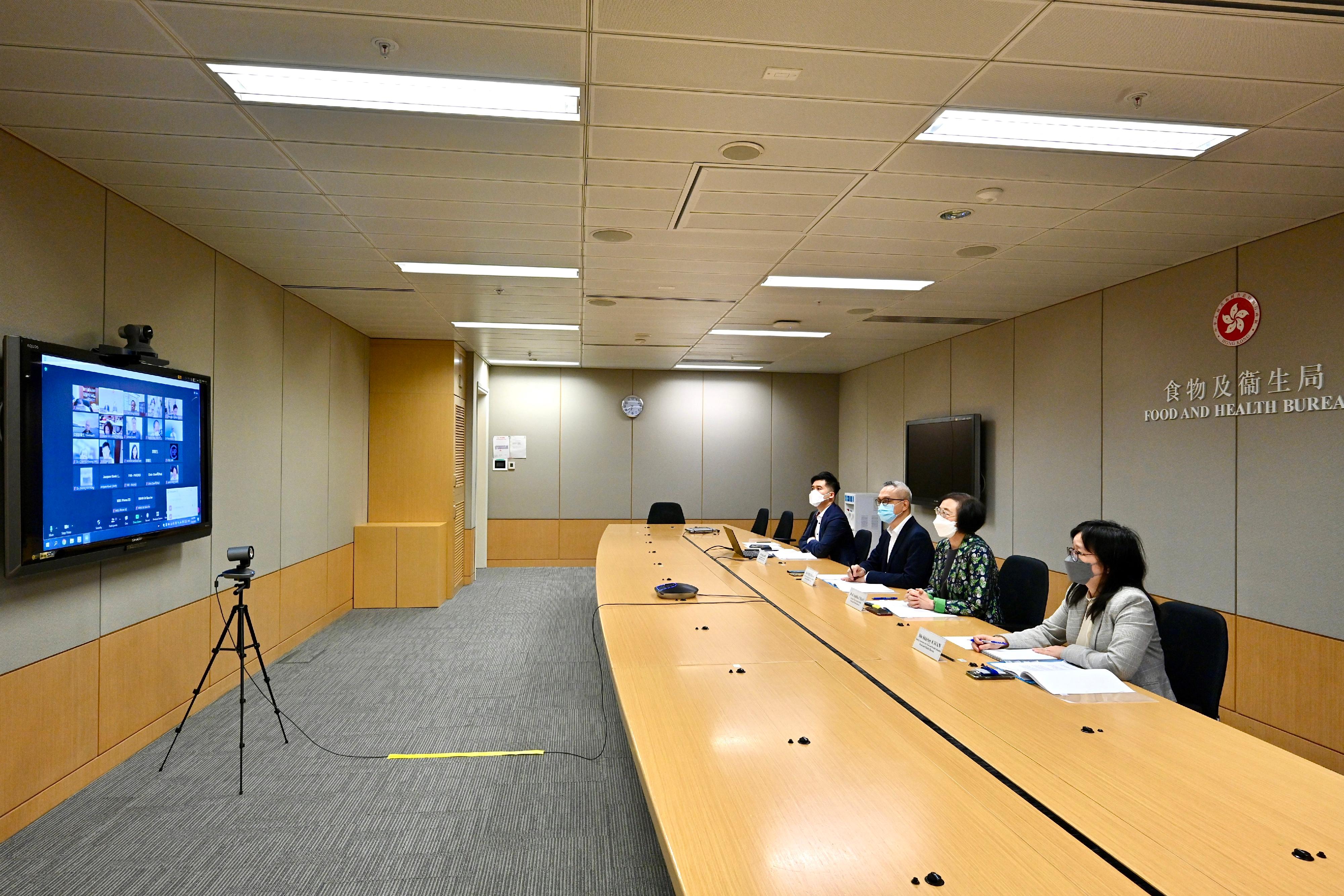 The Secretary for Food and Health, Professor Sophia Chan (second right), had a meeting with over 20 representatives of the medical and health sector from various healthcare professional bodies, medical organisations and medical institutions via video conferencing today (April 14) to appeal to the private healthcare sector to continue to unite in the fight against the epidemic by helping to treat COVID-19 patients and getting prepared for the phased resumption of face-to-face classes in schools, so as to cope with the possible rebound in the number of confirmed cases of COVID-19 after the resumption of face-to-face classes. The Under Secretary for Food and Health, Dr Chui Tak-yi (second left); and the Deputy Secretary for Food and Health (Health), Ms Shirley Kwan (first right), also attended.