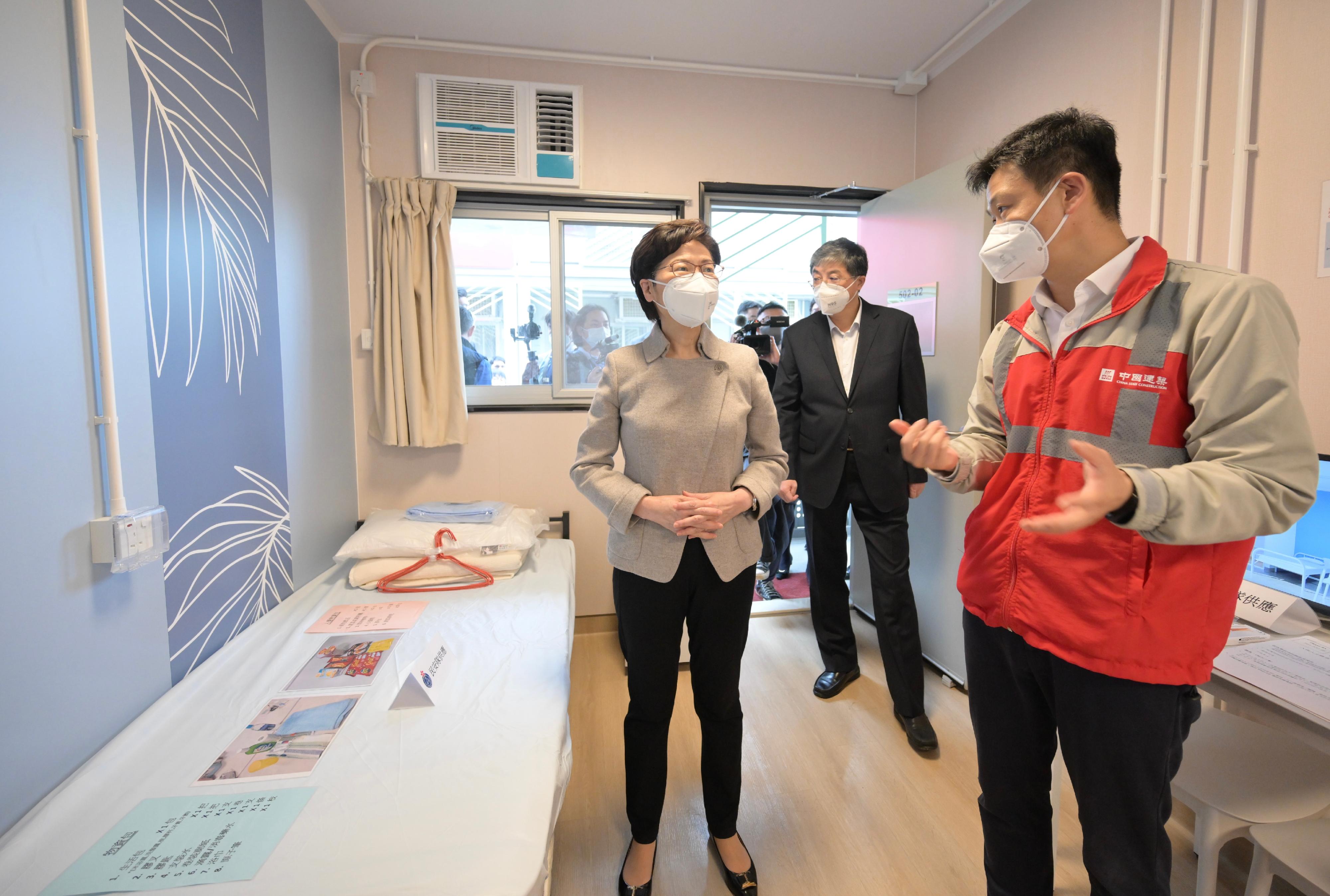 The Chief Executive, Mrs Carrie Lam, this afternoon (April 19) inspected the handover of the first phase of the Penny's Bay Community Isolation Facility constructed with Mainland support. Photo shows Mrs Lam (left), accompanied by a representative of the contractor, touring a newly constructed unit. Looking on is the Deputy Director of the Liaison Office of the Central People's Government in the Hong Kong Special Administrative Region, Mr Luo Yonggang (centre).