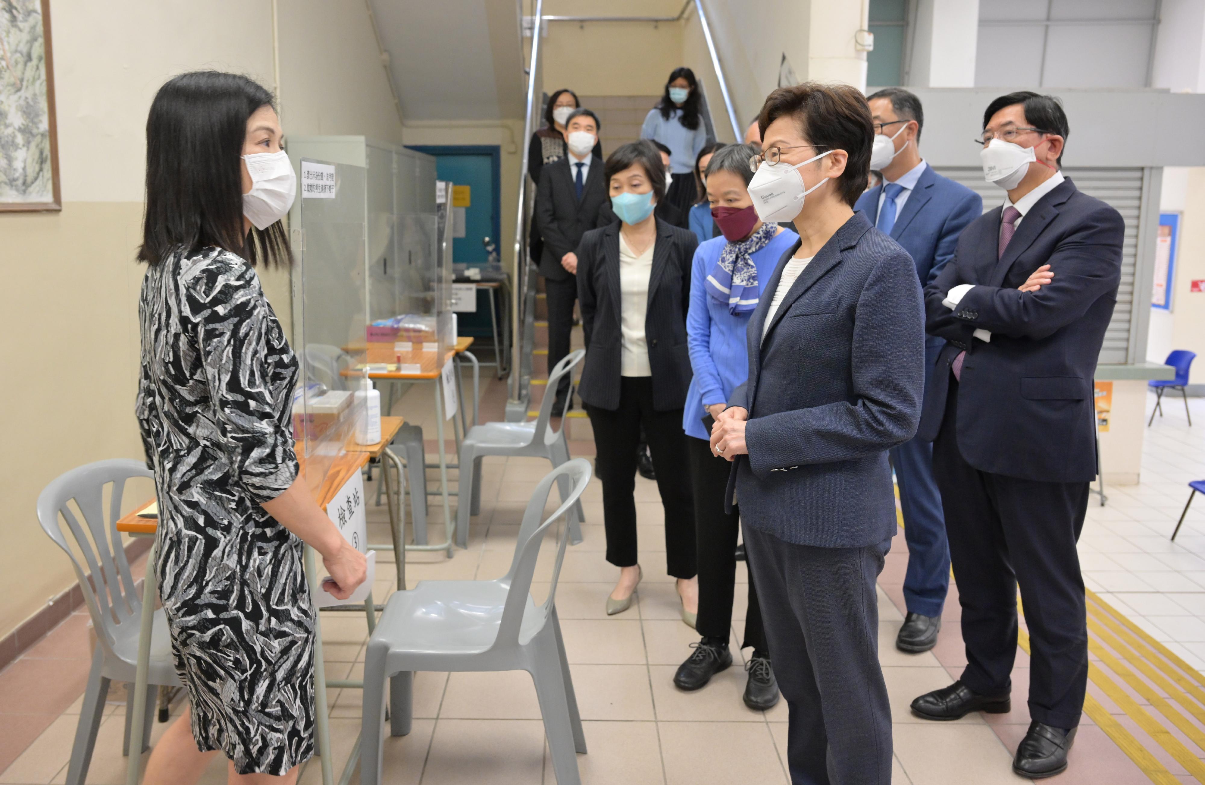 The Chief Executive, Mrs Carrie Lam, today (April 21) visited Clementi Secondary School, one of the examination centres of the Hong Kong Diploma of Secondary Education Examination, to learn more about the anti-epidemic measures in place at the school. Photo shows Mrs Lam (third right) receiving a briefing by the Principal of Clementi Secondary School, Ms Bonnie Lai (first left), on the relevant work. Looking on are the Under Secretary for Education, Dr Choi Yuk-lin (fifth right), and the Chairman of the Hong Kong Examinations and Assessment Authority, Mr Samuel Yung (first right).