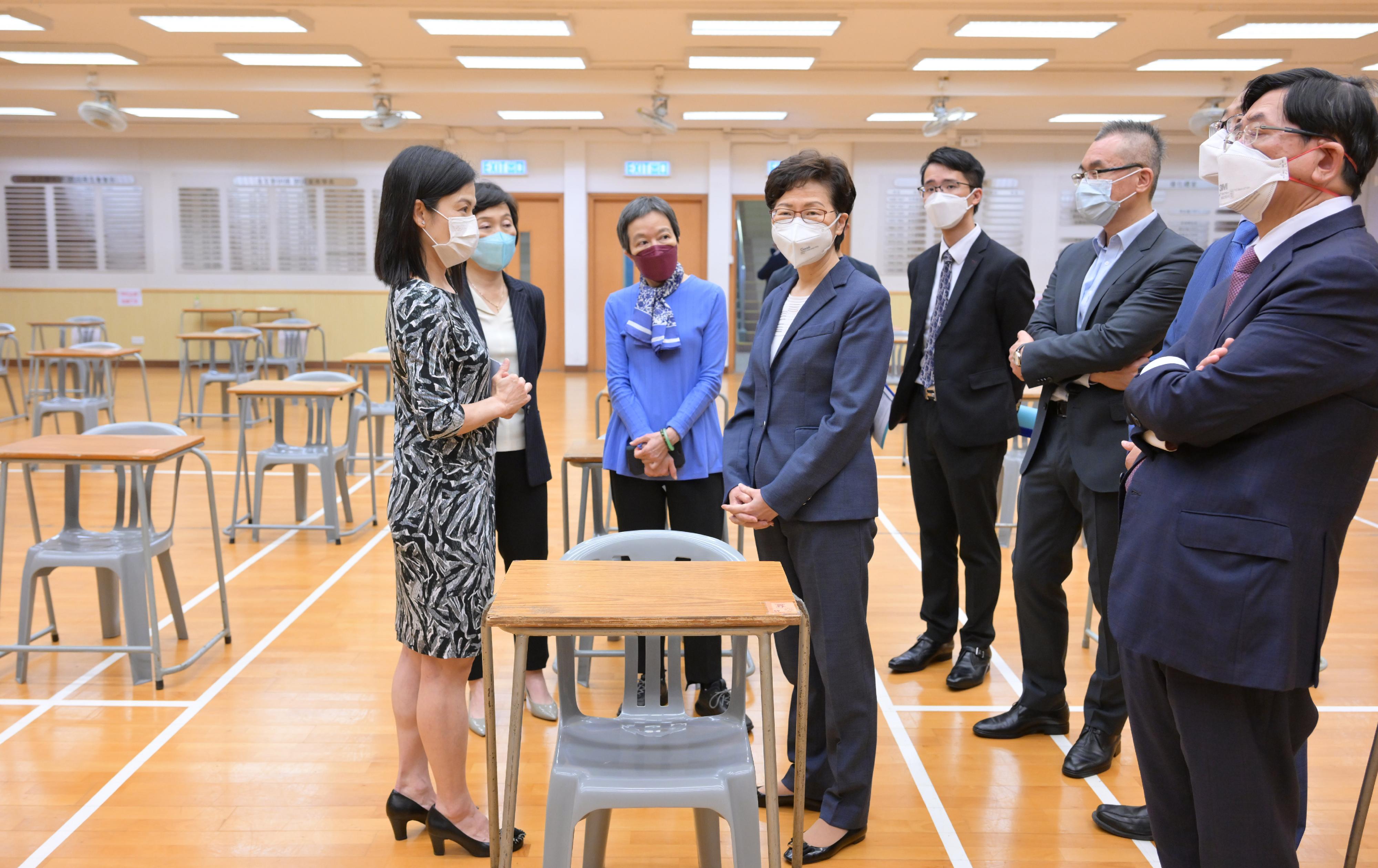 The Chief Executive, Mrs Carrie Lam, today (April 21) visited Clementi Secondary School, one of the examination centres of the Hong Kong Diploma of Secondary Education Examination, to learn more about the anti-epidemic measures in place at the school. Photo shows Mrs Lam (fourth right) receiving a briefing by the Principal of Clementi Secondary School, Ms Bonnie Lai (first left), on the relevant work. Looking on are the Under Secretary for Education, Dr Choi Yuk-lin (second left), and the Chairman of the Hong Kong Examinations and Assessment Authority, Mr Samuel Yung (first right).