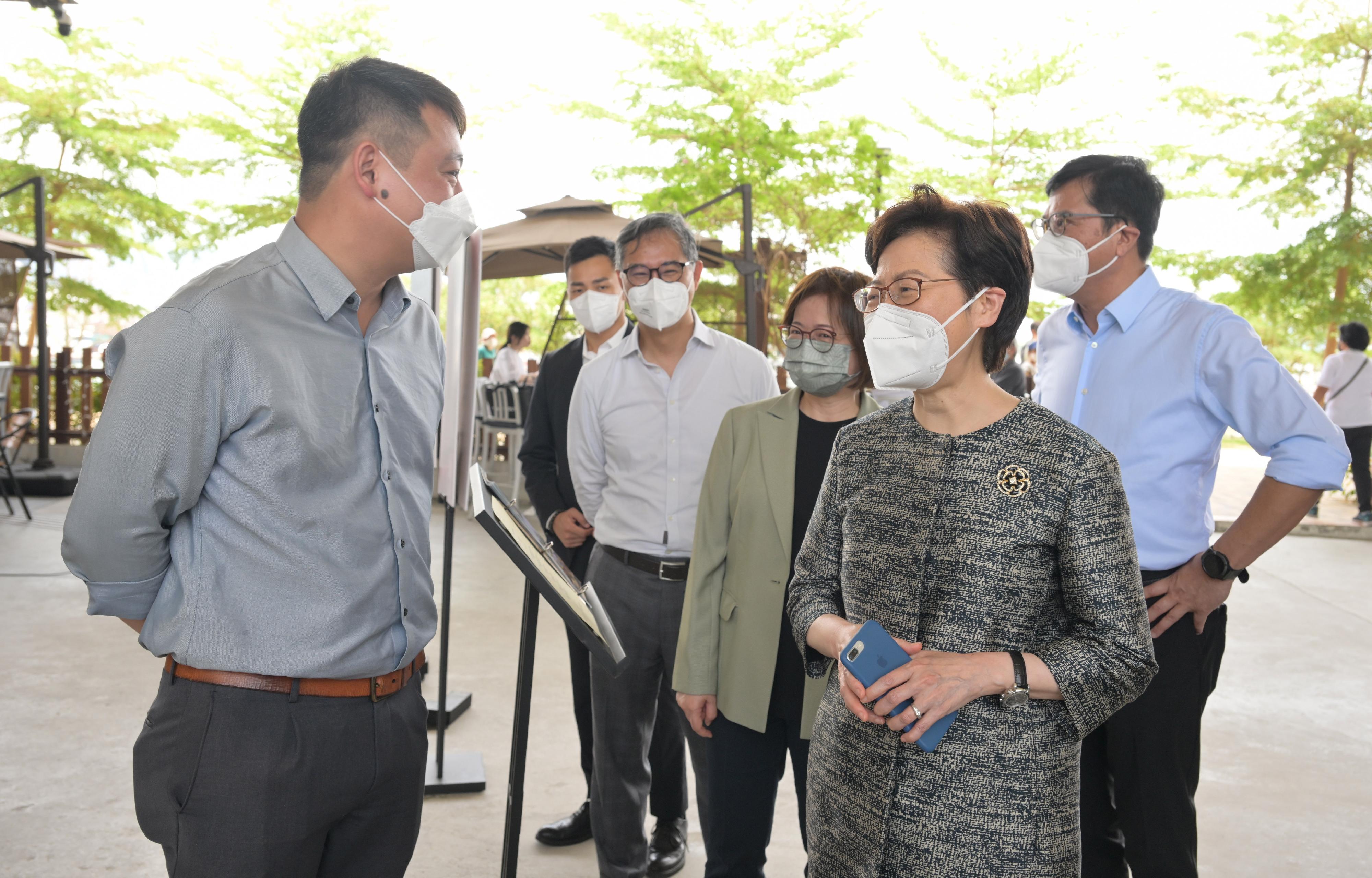 The Chief Executive, Mrs Carrie Lam, today (April 29) visited the Energizing Kowloon East Office (EKEO) and toured the area to survey the latest developments of the Energizing Kowloon East initiative. Photo shows Mrs Lam (second right) chatting with a representative of a restaurant at a venue of the Fly the Flyover Operation. Looking on are the Secretary for Development, Mr Michael Wong (first right); the Permanent Secretary for Development (Works), Mr Ricky Lau (fourth right); and the Head of the EKEO, Ms Amy Cheung (third right).
