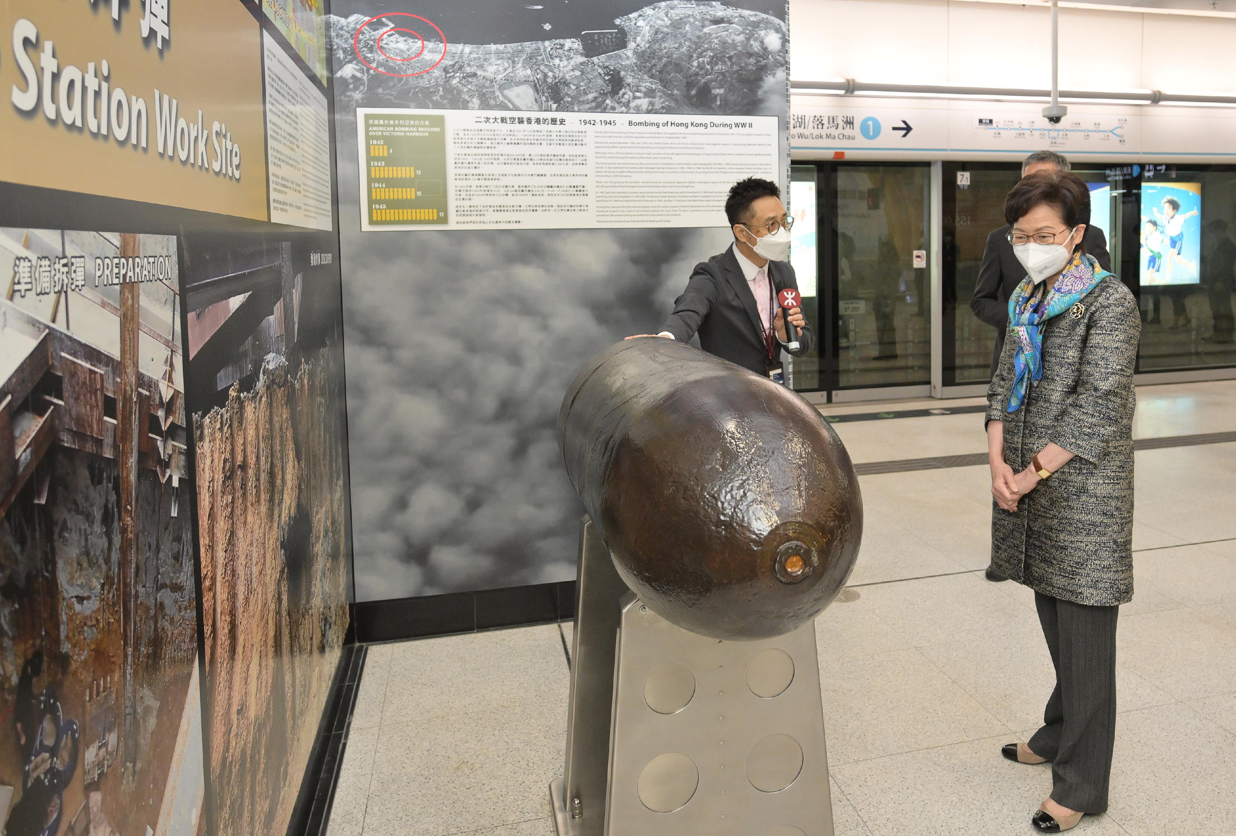 The Chief Executive, Mrs Carrie Lam, visited Wan Chai North today (May 4) to view the newly constructed Exhibition Centre Station of the East Rail Line cross-harbour extension and the neighbouring facilities. Photo shows Mrs Lam (right) viewing the casing of a bomb dropped during World War II discovered in the course of excavation work.