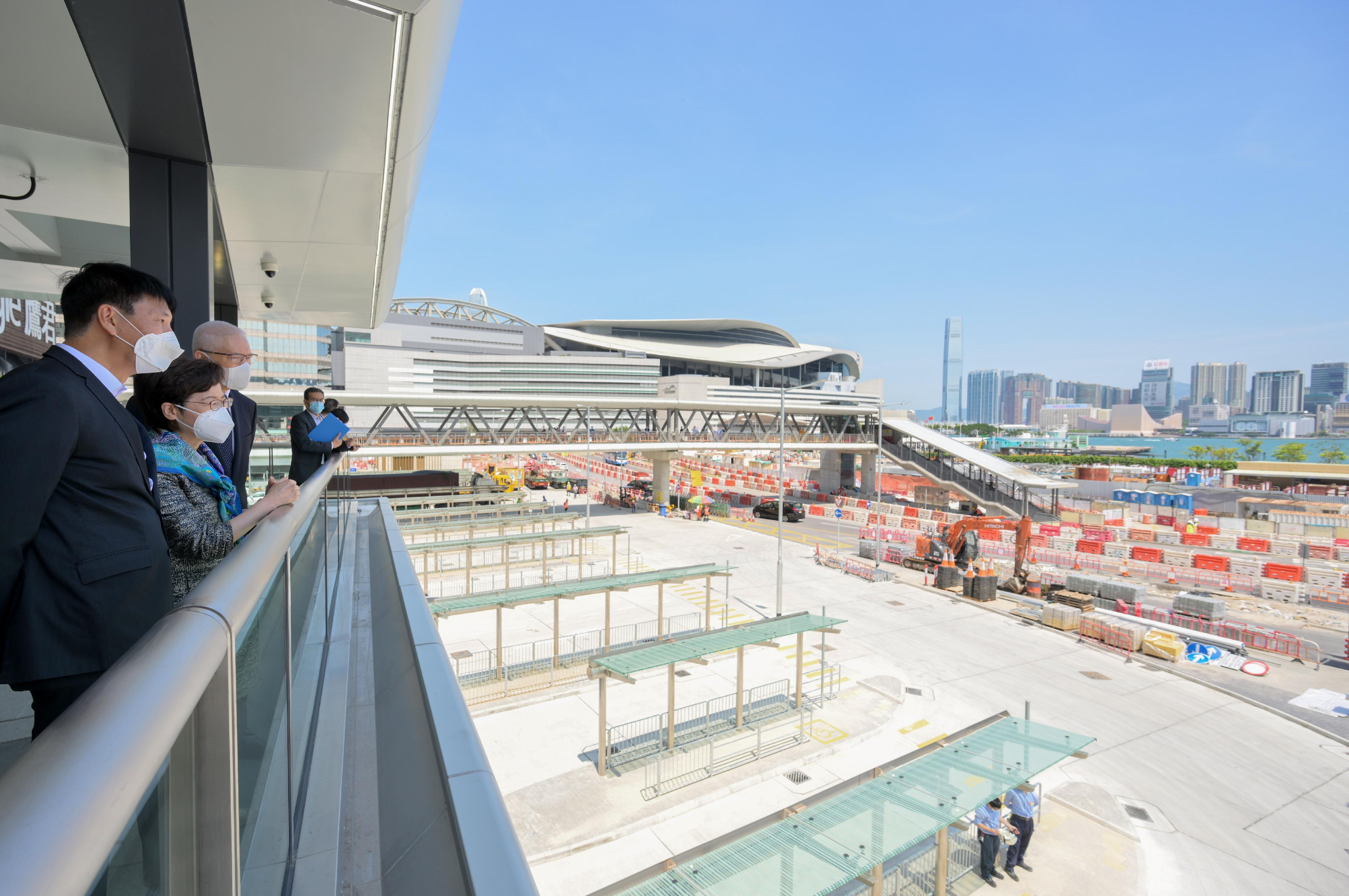 The Chief Executive, Mrs Carrie Lam, visited Wan Chai North today (May 4) to view the newly constructed Exhibition Centre Station of the East Rail Line cross-harbour extension and the neighbouring facilities. Photo shows Mrs Lam (second left) looking at the transportation facilities near Exhibition Centre Station. Also present are the Director of Highways, Mr Jimmy Chan (first left), and the Chairman of the MTR Corporation Limited, Dr Rex Auyeung (third left).