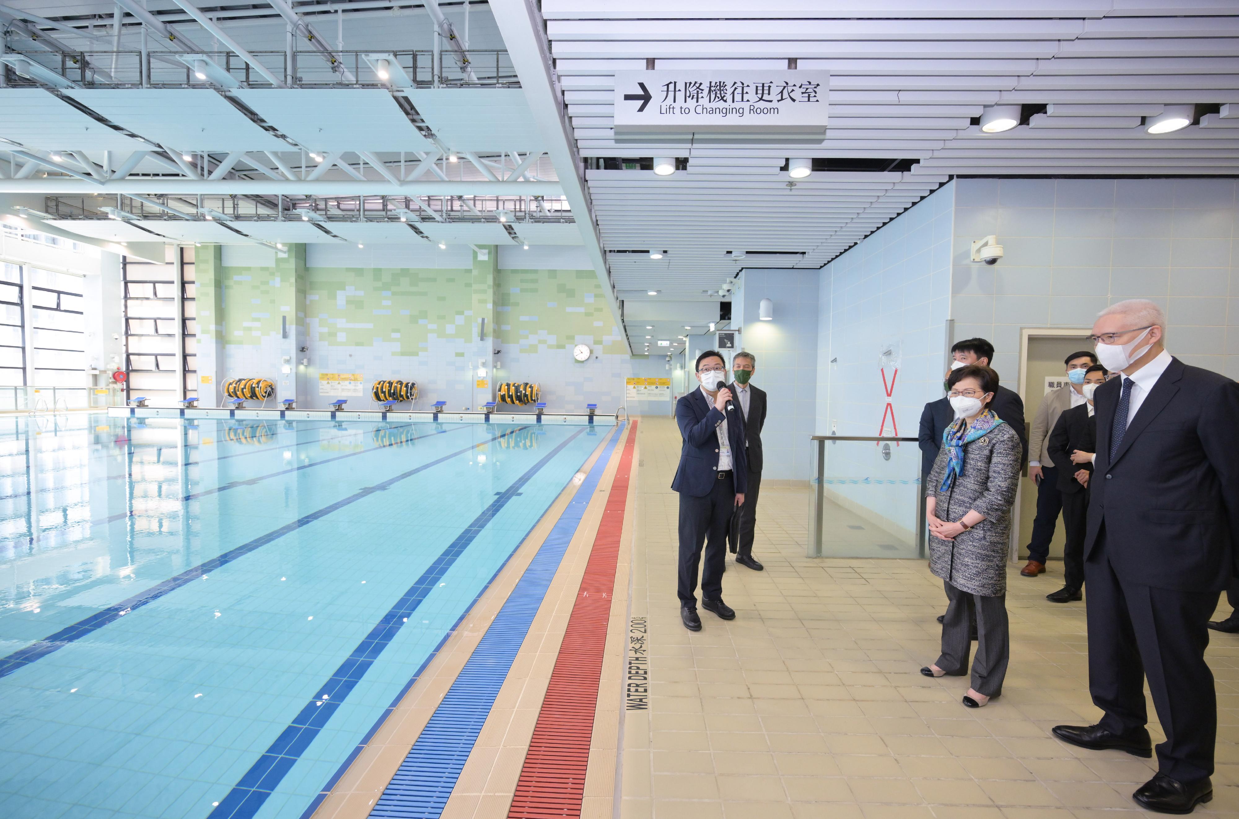The Chief Executive, Mrs Carrie Lam, visited Wan Chai North today (May 4) to view the newly constructed Exhibition Centre Station of the East Rail Line cross-harbour extension and the neighbouring facilities. Photo shows Mrs Lam (second right) touring Wan Chai Swimming Pool and being briefed by a representative of the Leisure and Cultural Services Department on the facilities there. Looking on is the Chairman of the MTR Corporation Limited, Dr Rex Auyeung (first right).