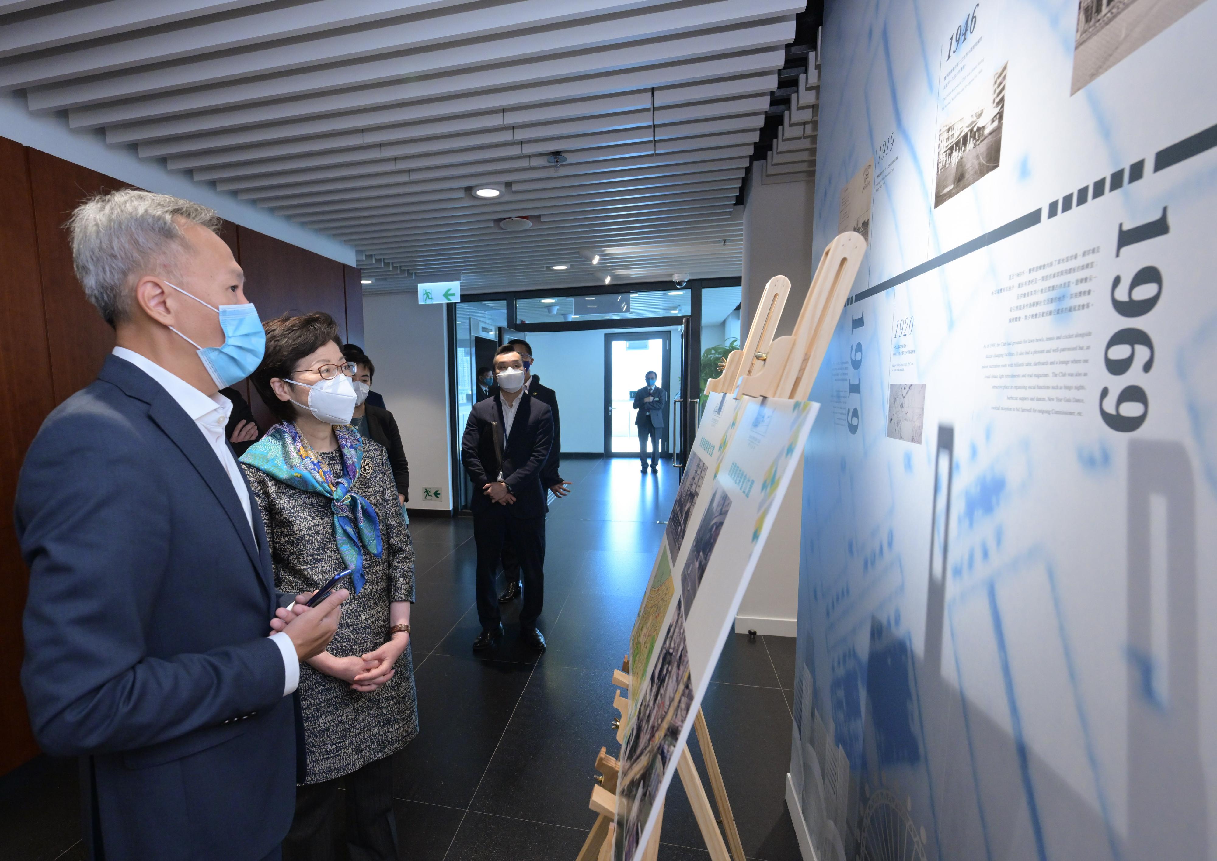 The Chief Executive, Mrs Carrie Lam, visited Wan Chai North today (May 4) to view the newly constructed Exhibition Centre Station of the East Rail Line cross-harbour extension and the neighbouring facilities. Photo shows Mrs Lam (second left) viewing exhibition panels on the history of the Police Officers' Club.