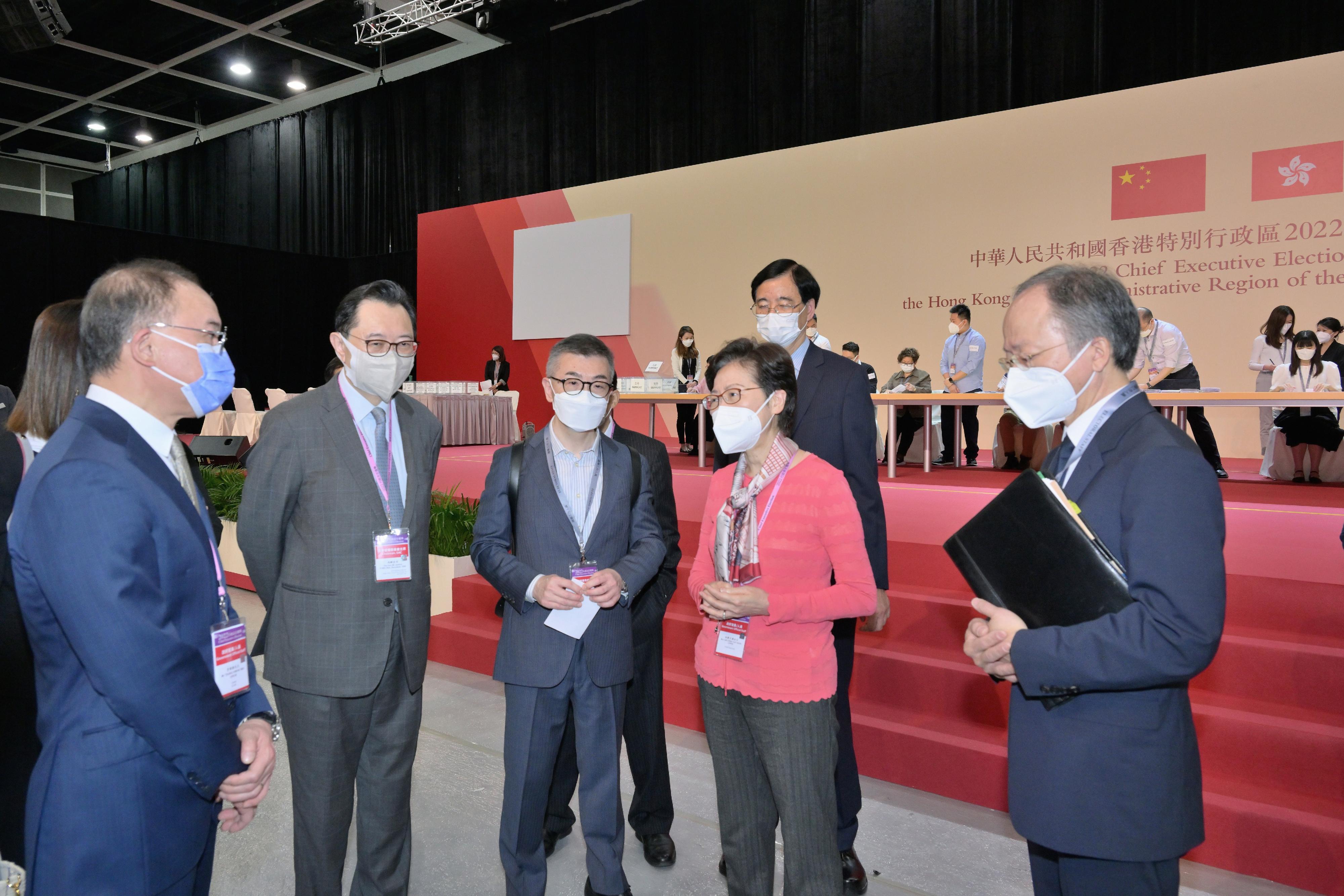 The Chief Executive, Mrs Carrie Lam (fourth left), accompanied by the Secretary for Constitutional and Mainland Affairs, Mr Erick Tsang Kwok-wai (first left), and the Chairman of the Electoral Affairs Commission, Mr Justice Barnabas Fung Wah (second left), visits the main polling station and the central counting station of the Chief Executive Election in the Hong Kong Convention and Exhibition Centre this morning (May 7) to learn more about the final stage of the preparatory work for the election.