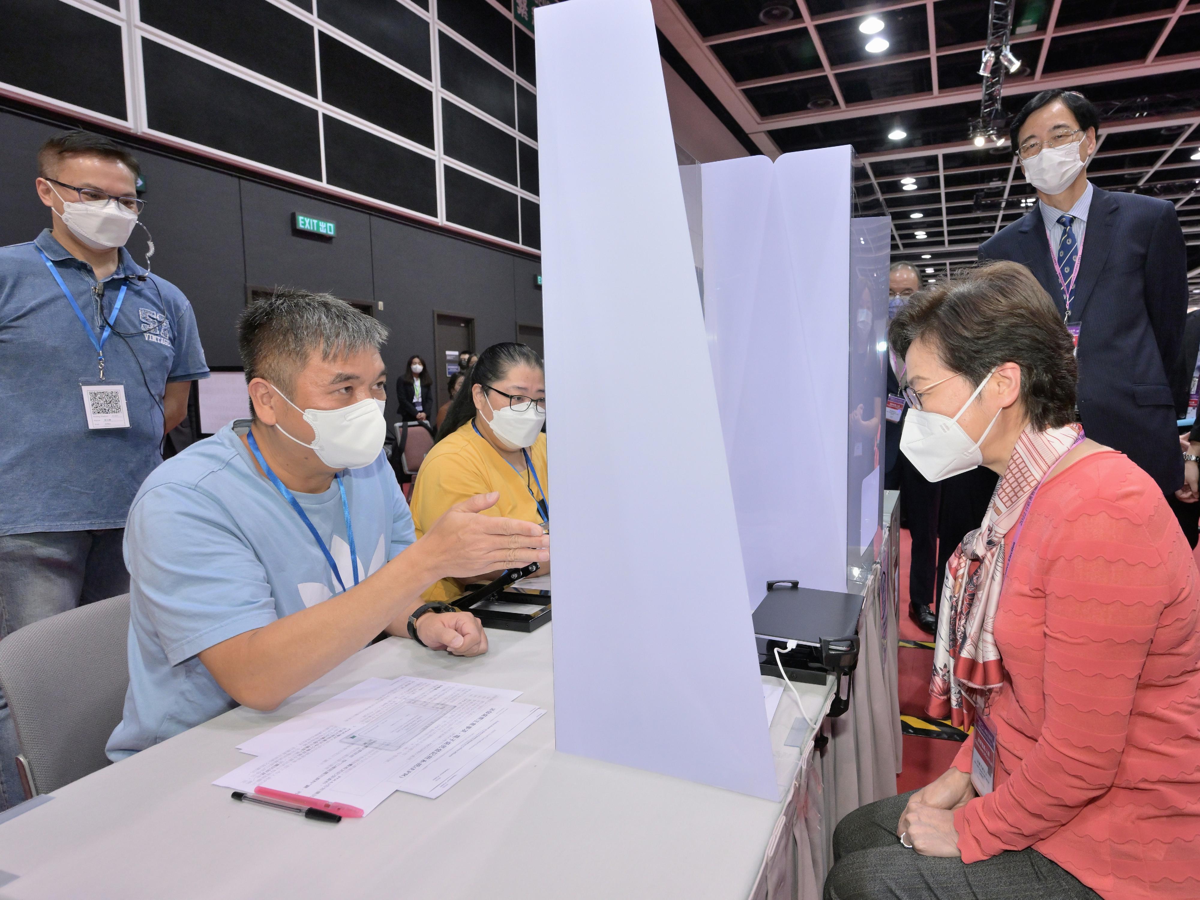 The Chief Executive, Mrs Carrie Lam (right), accompanied by the Secretary for Constitutional and Mainland Affairs, Mr Erick Tsang Kwok-wai, and the Chairman of the Electoral Affairs Commission, Mr Justice Barnabas Fung Wah, visits the main polling station and the central counting station of the Chief Executive Election at the Hong Kong Convention and Exhibition Centre this morning (May 7) to learn more about the final stage of the preparatory work for the election. Photo shows Mrs Lam experiencing the voting process.