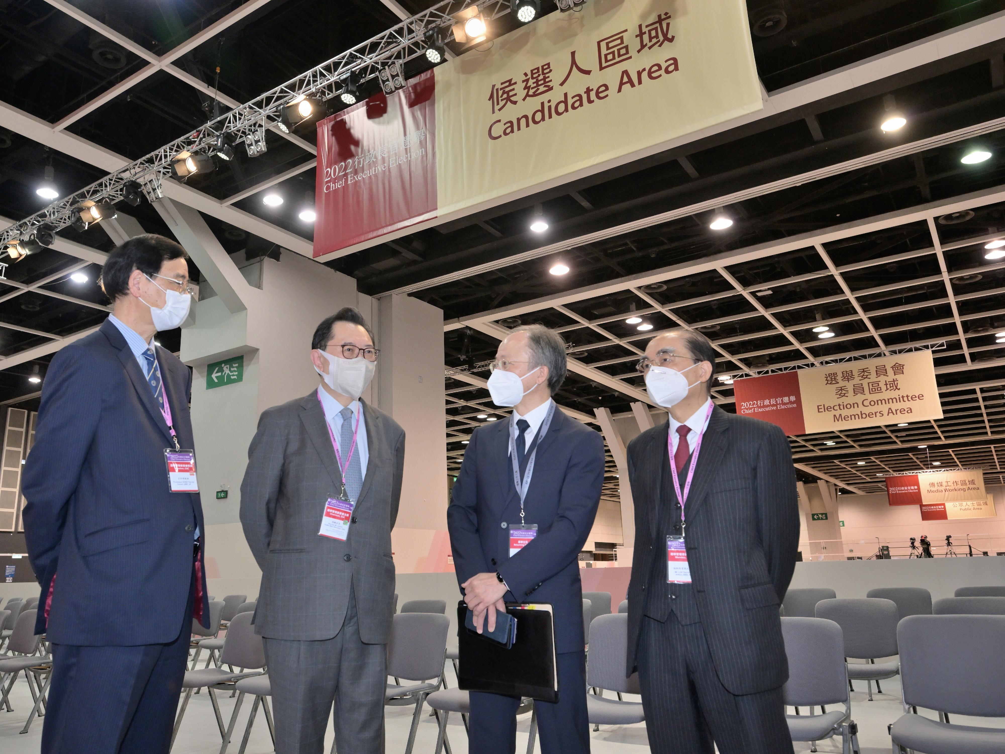 The Chairman of the Electoral Affairs Commission (EAC), Mr Justice Barnabas Fung Wah (second left), EAC members Mr Arthur Luk, SC (first right), and Professor Daniel Shek (first left), and the Returning Officer, Mr Justice Keith Yeung Kar-hung (second right), visit the central counting station cum media centre of the 2022 Chief Executive Election at the Hong Kong Convention and Exhibition Centre in Wan Chai today (May 7).