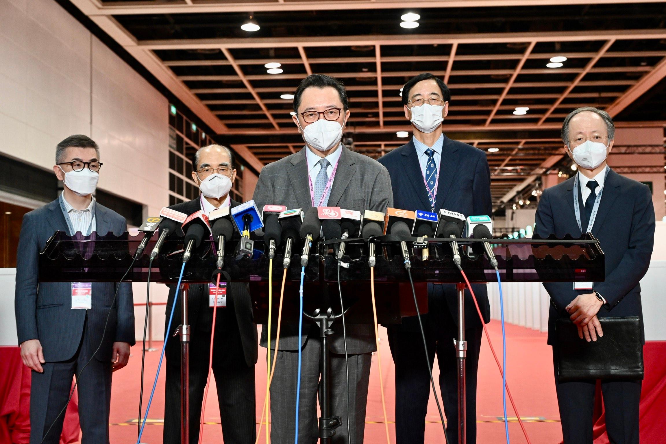 The Chairman of the Electoral Affairs Commission (EAC), Mr Justice Barnabas Fung Wah (centre); EAC members Mr Arthur Luk, SC (second left), and Professor Daniel Shek (second right); the Returning Officer, Mr Justice Keith Yeung Kar-hung (first right); and the Chief Electoral Officer, Mr Raymond Wang (first left), meet the media today (May 7) after visiting the main polling station of the 2022 Chief Executive Election at the Hong Kong Convention and Exhibition Centre in Wan Chai.