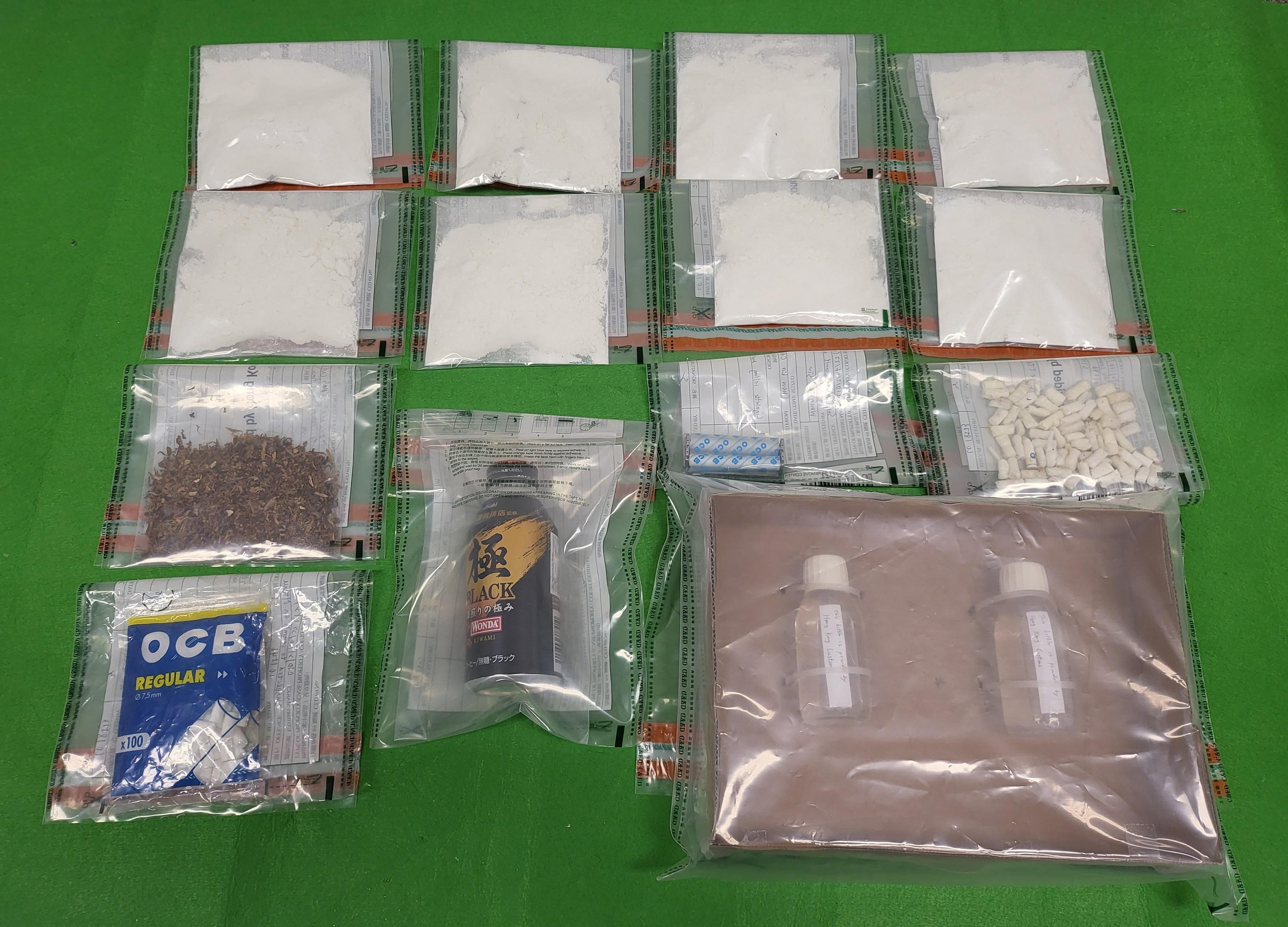 Hong Kong Customs seized about 600 grams of suspected cocaine with an estimated market value of about $660,000 at Hong Kong International Airport on May 5. Customs officers later arrested a man suspected to be connected with the case and further seized a small quantity of suspected cocaine and a set of drug-inhaling apparatus at the arrested man's residence. Photo shows the suspected cocaine and the drug-inhaling apparatus seized.
