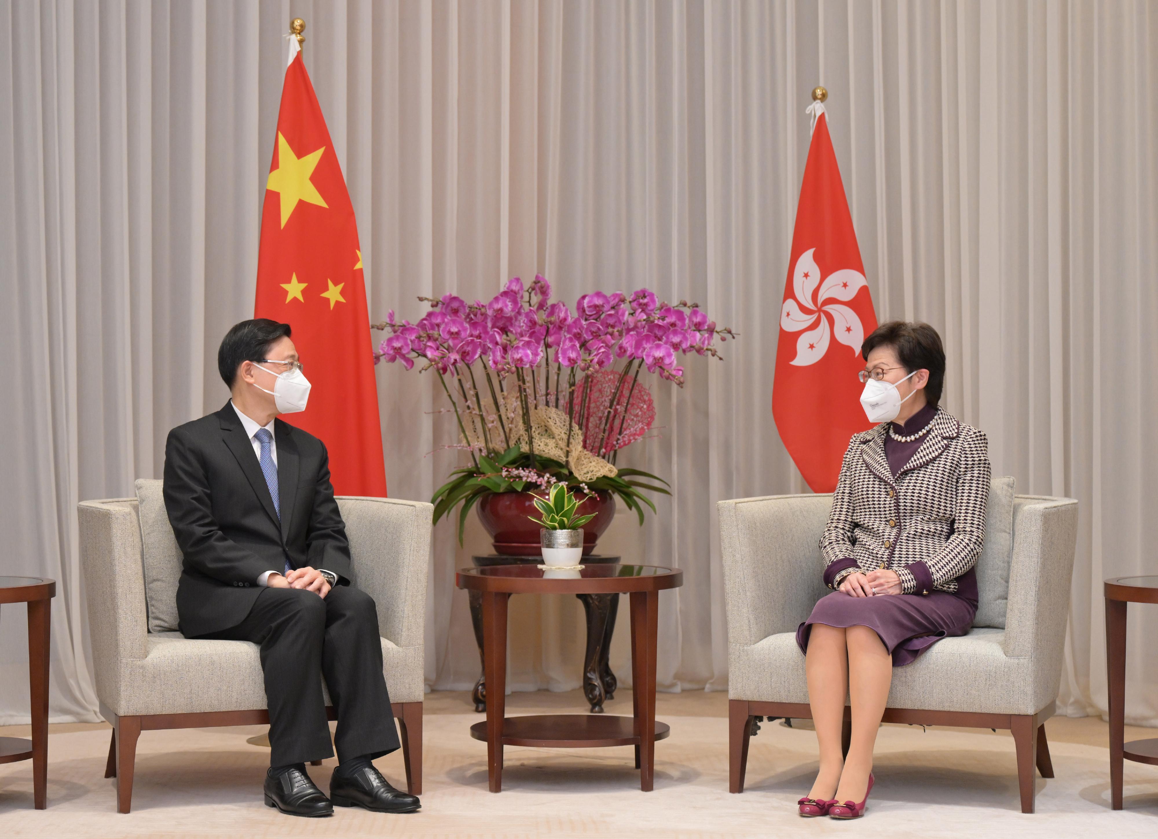 The Chief Executive, Mrs Carrie Lam (right), meets with the sixth-term Chief Executive-elect, Mr John Lee (left), at the Chief Executive's Office this morning (May 9).
