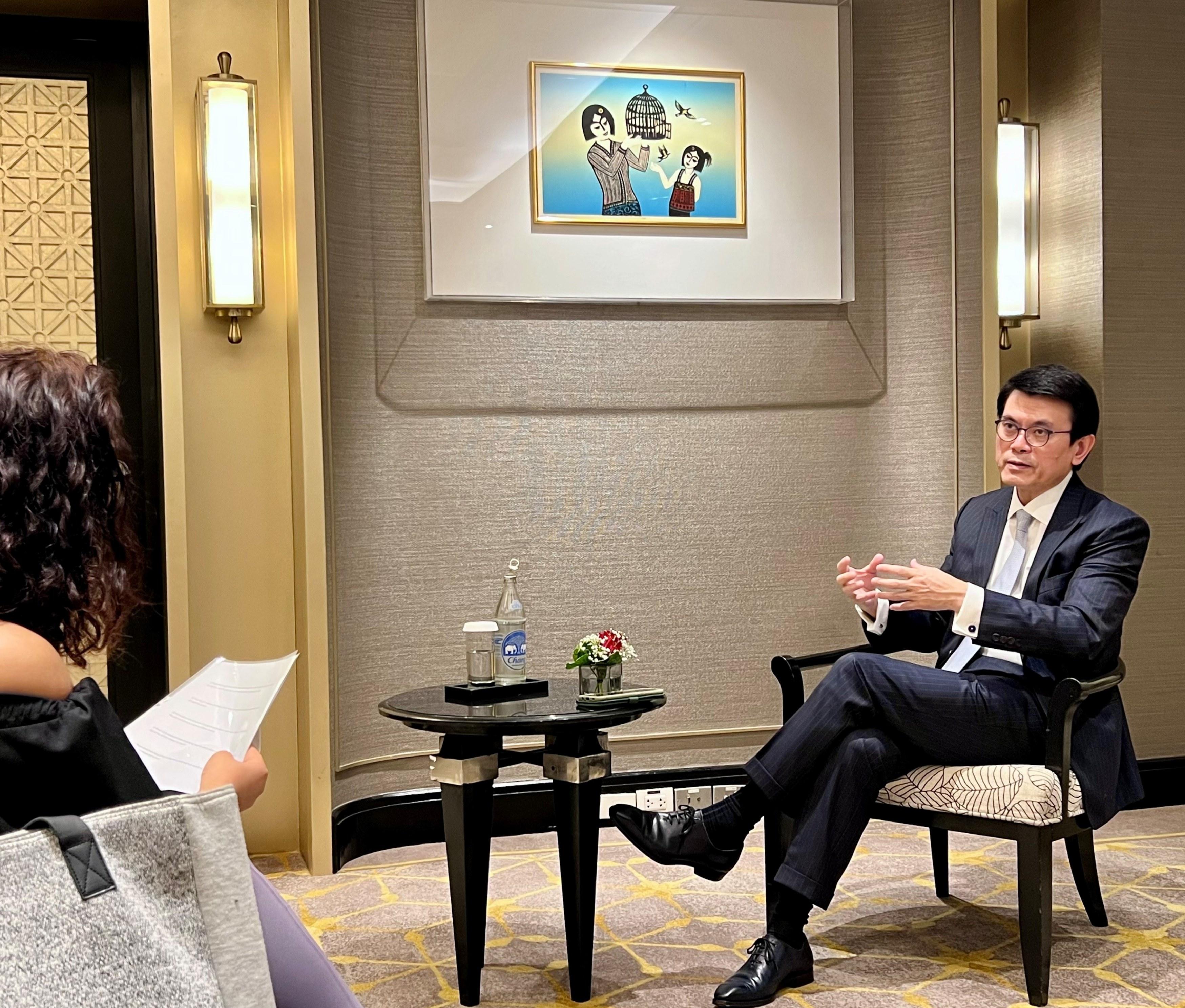 The Secretary for Commerce and Economic Development, Mr Edward Yau, continued to promote Hong Kong's business opportunities on his visit to Bangkok, Thailand, today (May 20). Photo shows Mr Yau giving an interview to local media.