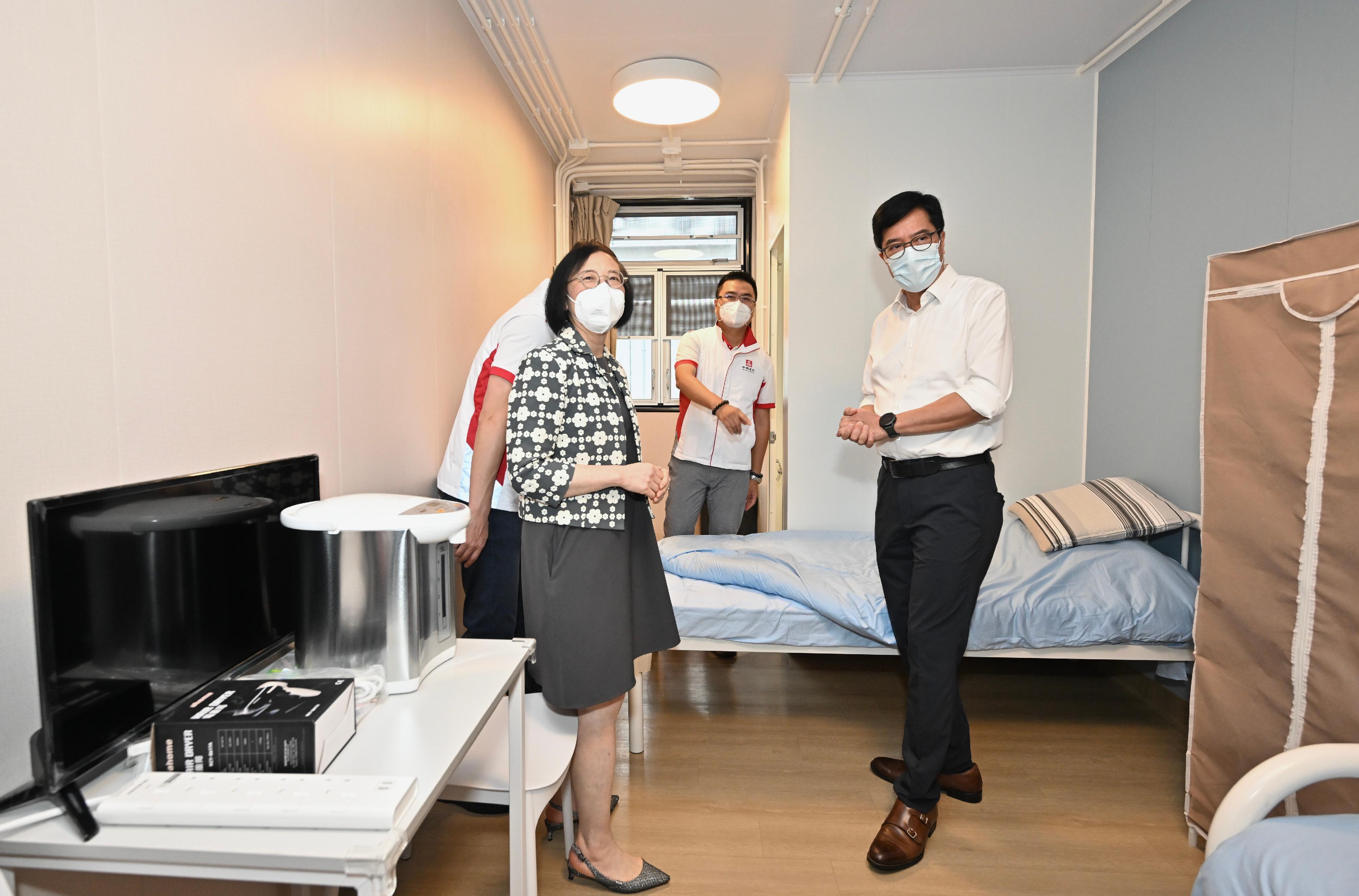 The Secretary for Development, Mr Michael Wong, and the Secretary for Food and Health, Professor Sophia Chan, visited the Kai Tak Community Isolation Facility this afternoon (May 27). Photo shows Mr Wong (first right) and Professor Chan (first left), accompanied by a representative of the contractor, touring an isolation unit.