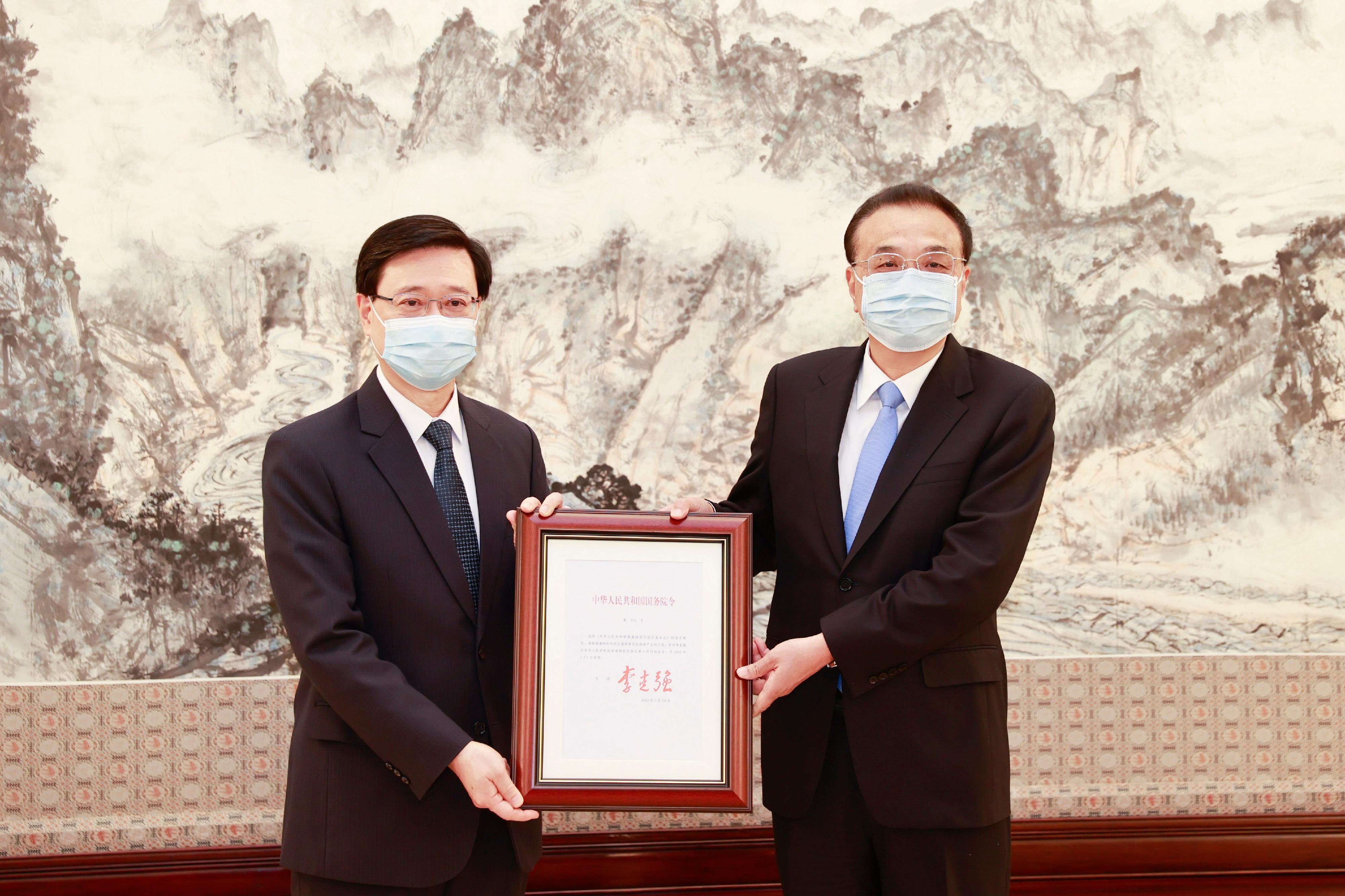 候任行政長官李家超（左）今日（五月三十日）在北京接受國務院總理李克強（右）頒發《國務院令》，任命他為中華人民共和國香港特別行政區第六任行政長官。