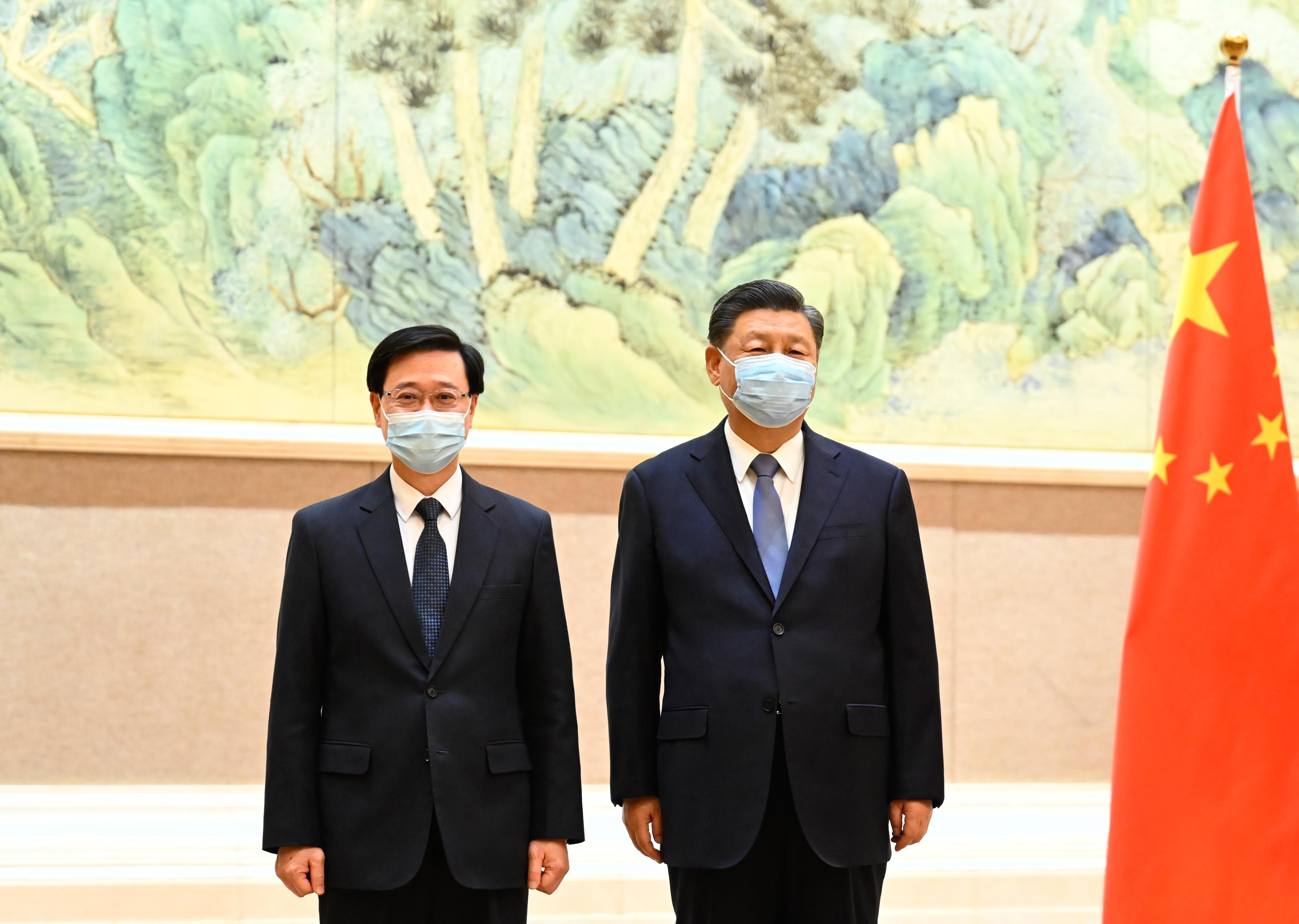 The Chief Executive-elect, Mr John Lee (left), is received by President Xi Jinping (right) in Beijing today (May 30).