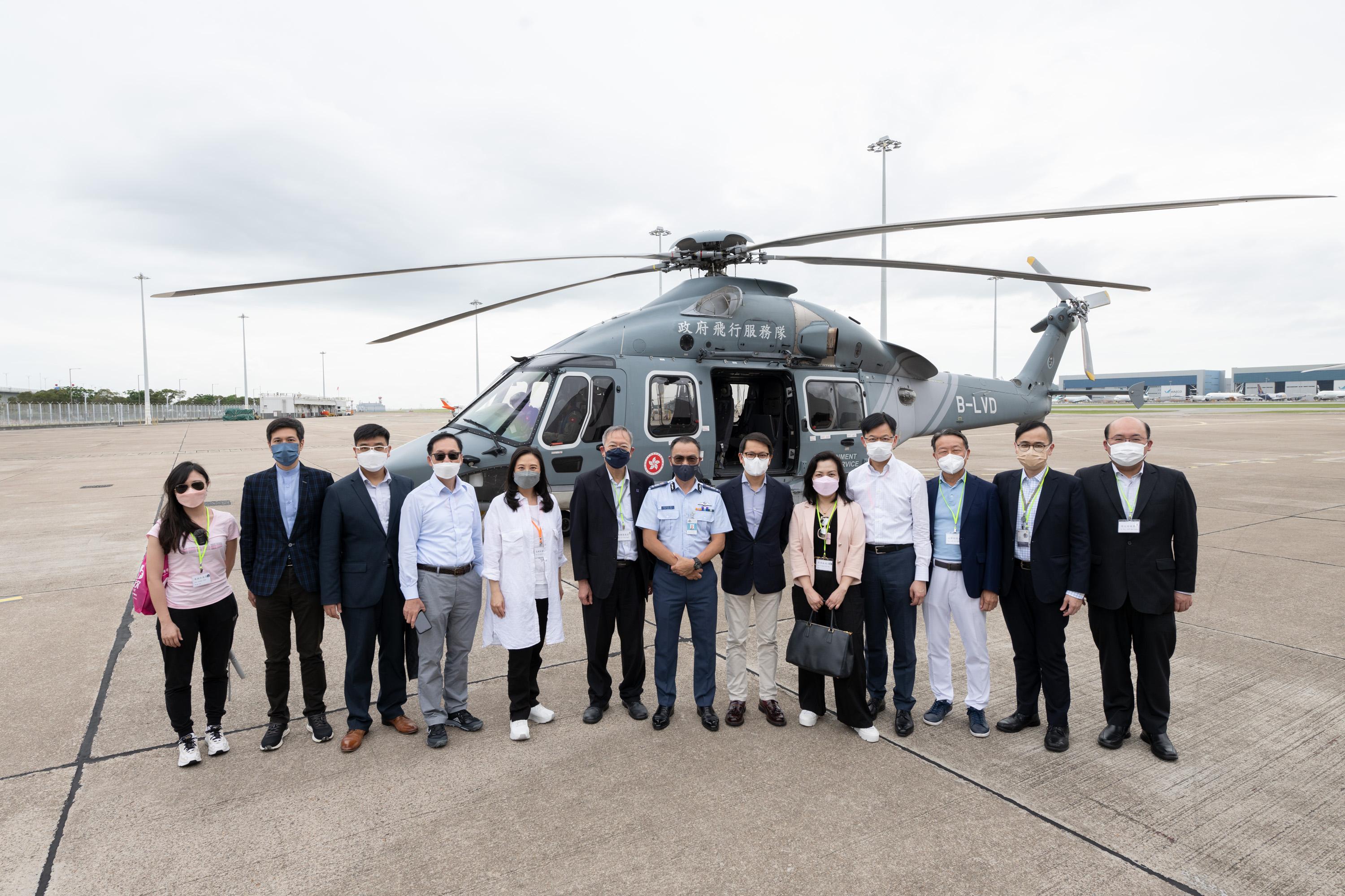 The Legislative Council Panel on Security visited the Government Flying Service (GFS) Headquarters today (May 31). Photo shows Panel members posing for a group photo with the Controller of GFS, Captain West Wu (centre), at the GFS Headquarters.