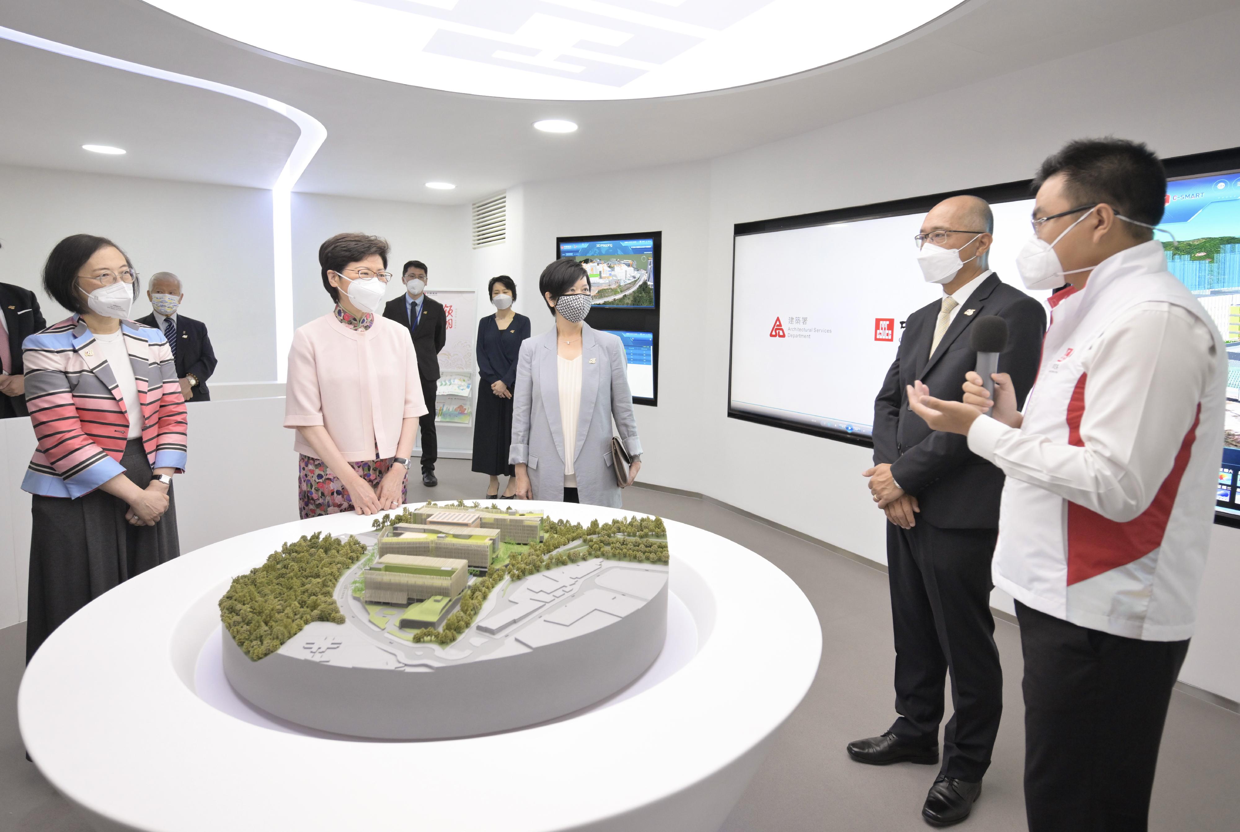 The Chief Executive, Mrs Carrie Lam, attended the Groundbreaking Ceremony of the Chinese Medicine Hospital and the Government Chinese Medicines Testing Institute today (June 2). Photo shows Mrs Lam (second left), accompanied by the Secretary for Food and Health, Professor Sophia Chan (first left), and the Director of Architectural Services, Ms Winnie Ho (third left), receiving a briefing from Executive Director and Vice President of China State Construction International Holdings Limited Mr Hung Cheung-shew (second right), and a staff member on the architectural features of the project.