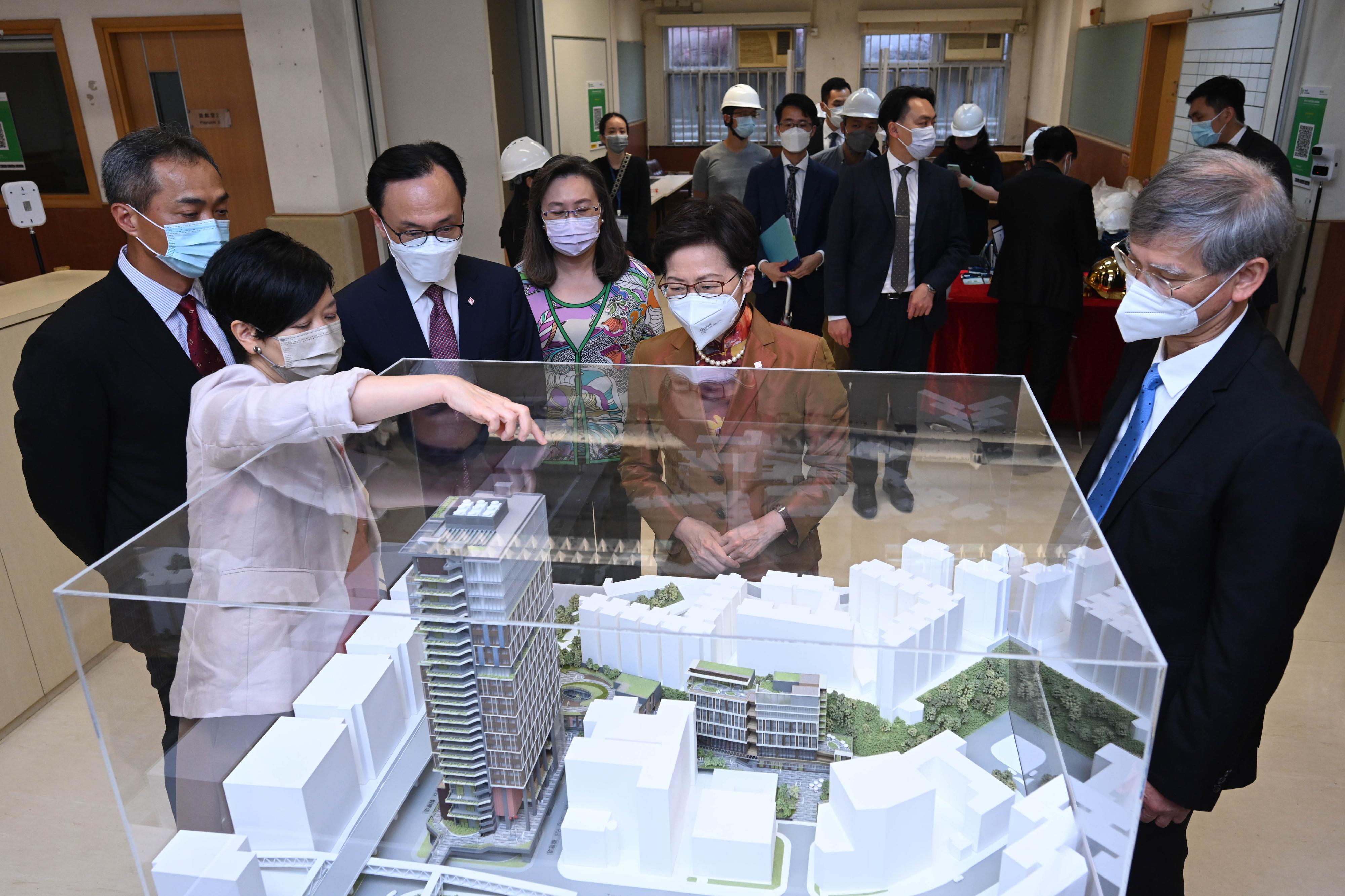 The Chief Executive, Mrs Carrie Lam, officiated at the Kwun Tong Composite Development Project and Civil Service College Ground Breaking Ceremony this afternoon (June 9). Photo shows Mrs Lam (second right), accompanied by the Secretary for Labour and Welfare, Dr Law Chi-kwong (first right); the Secretary for the Civil Service, Mr Patrick Nip (third left); the Permanent Secretary for the Civil Service, Mrs Ingrid Yeung (centre); and the Head of the Civil Service College (Designate), Mr Kwok Yam-shu (second left), being briefed by the Director of Architectural Services, Ms Winnie Ho (first left), on the project while viewing a model.