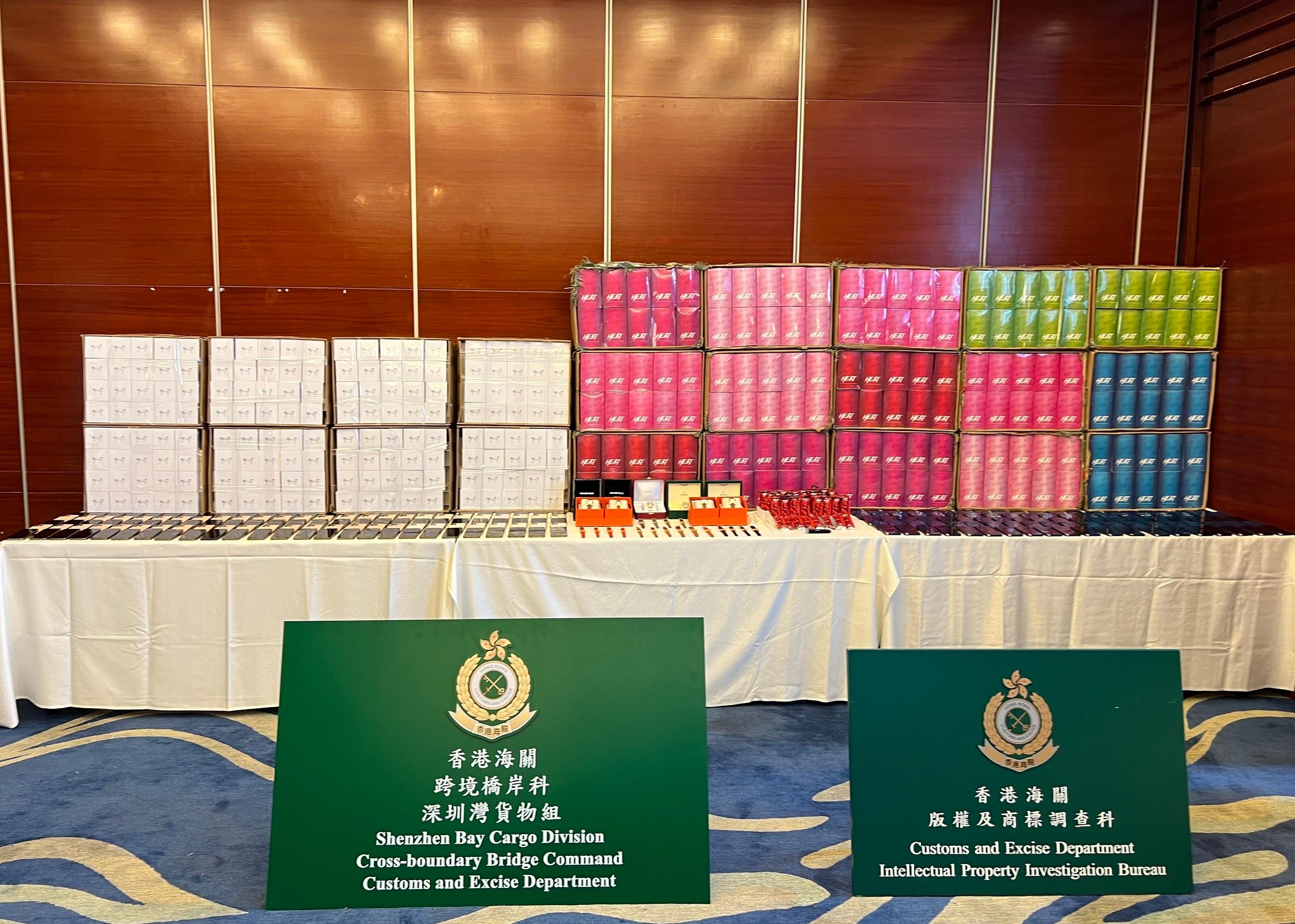 Hong Kong Customs conducted a series of operations between May 17 and June 9 to combat cross-boundary transshipment and local sale of counterfeit goods and detected 11 cases in total. About 10 000 items of suspected counterfeit goods, including footwear, mobile phones, clothing, watches, handbags and fashion accessories, and about 9 300 suspected alternative smoking products (ASPs), with an estimated market value of over $11.6 million, were seized. Photo shows some of the suspected counterfeit goods and suspected ASPs seized.