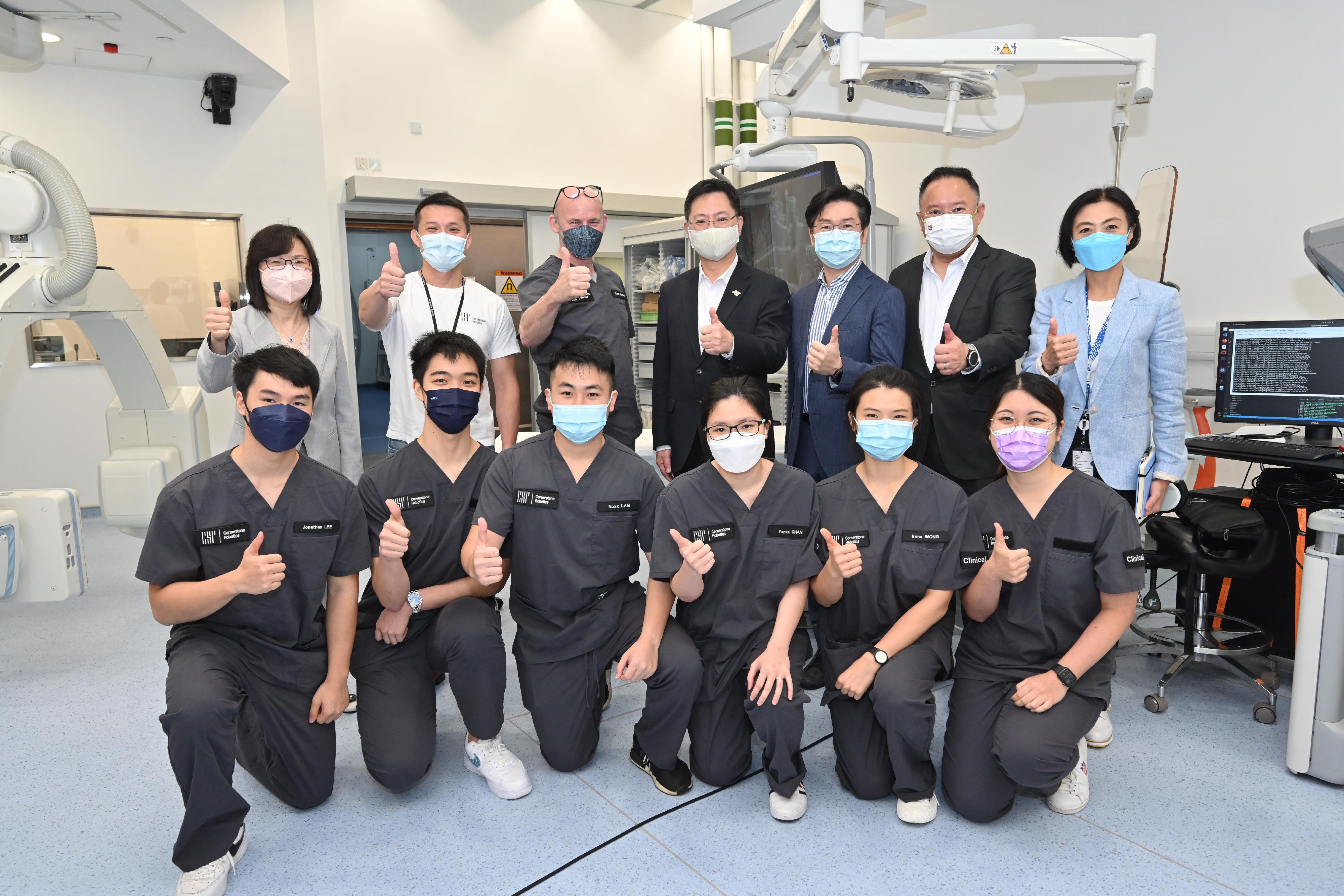 The Secretary for Innovation and Technology, Mr Alfred Sit (back row, centre), together with the Commissioner for Innovation and Technology, Ms Rebecca Pun (back row, first left), joins a group photo with the research team during the visit to the Multi-Scale Medical Robotics Center today (June 14).