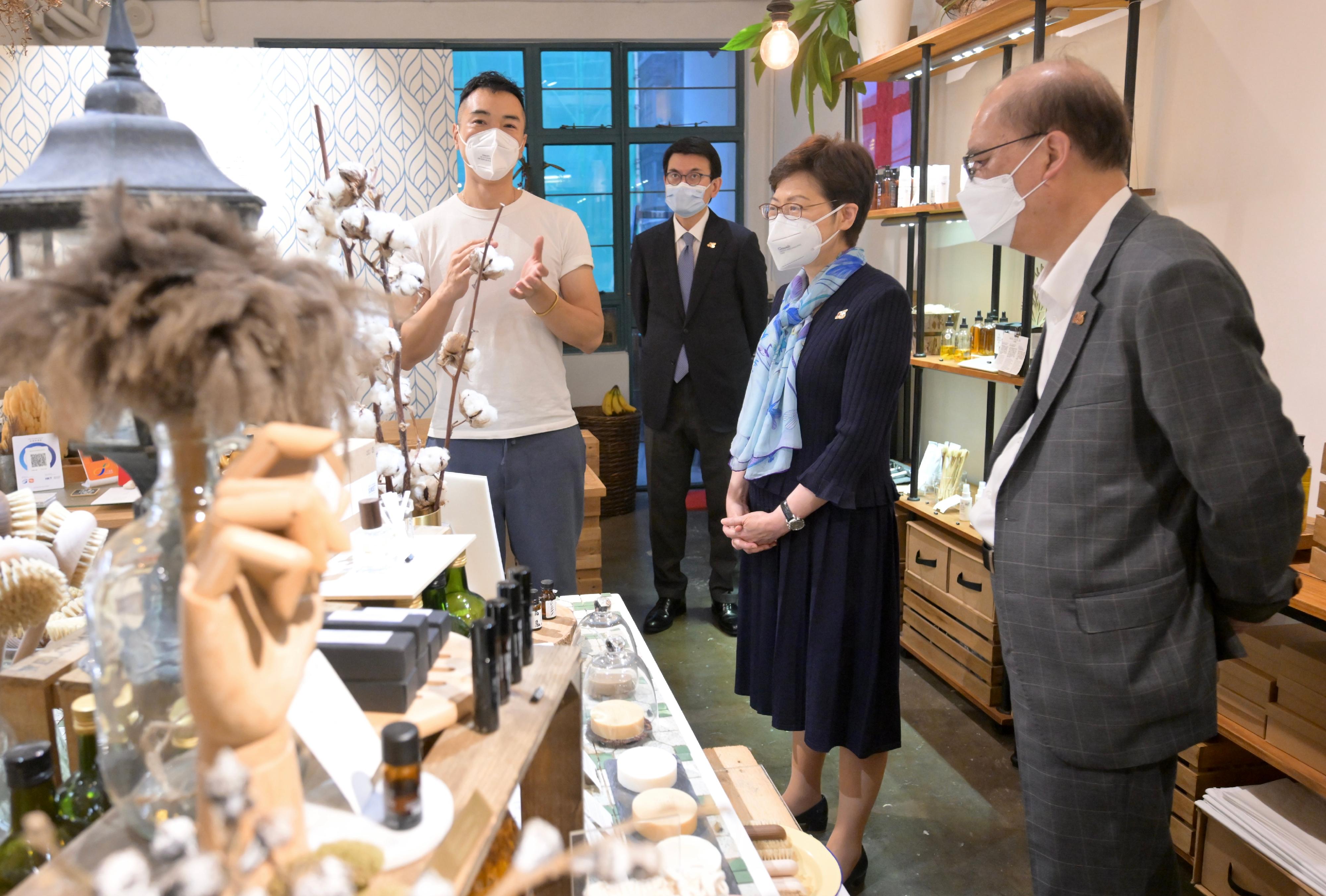 The Chief Executive, Mrs Carrie Lam, today (June 14) visited PMQ. Photo shows Mrs Lam (second right), accompanied by the Secretary for Commerce and Economic Development, Mr Edward Yau (second left), visiting a design studio and chatting with the tenant.