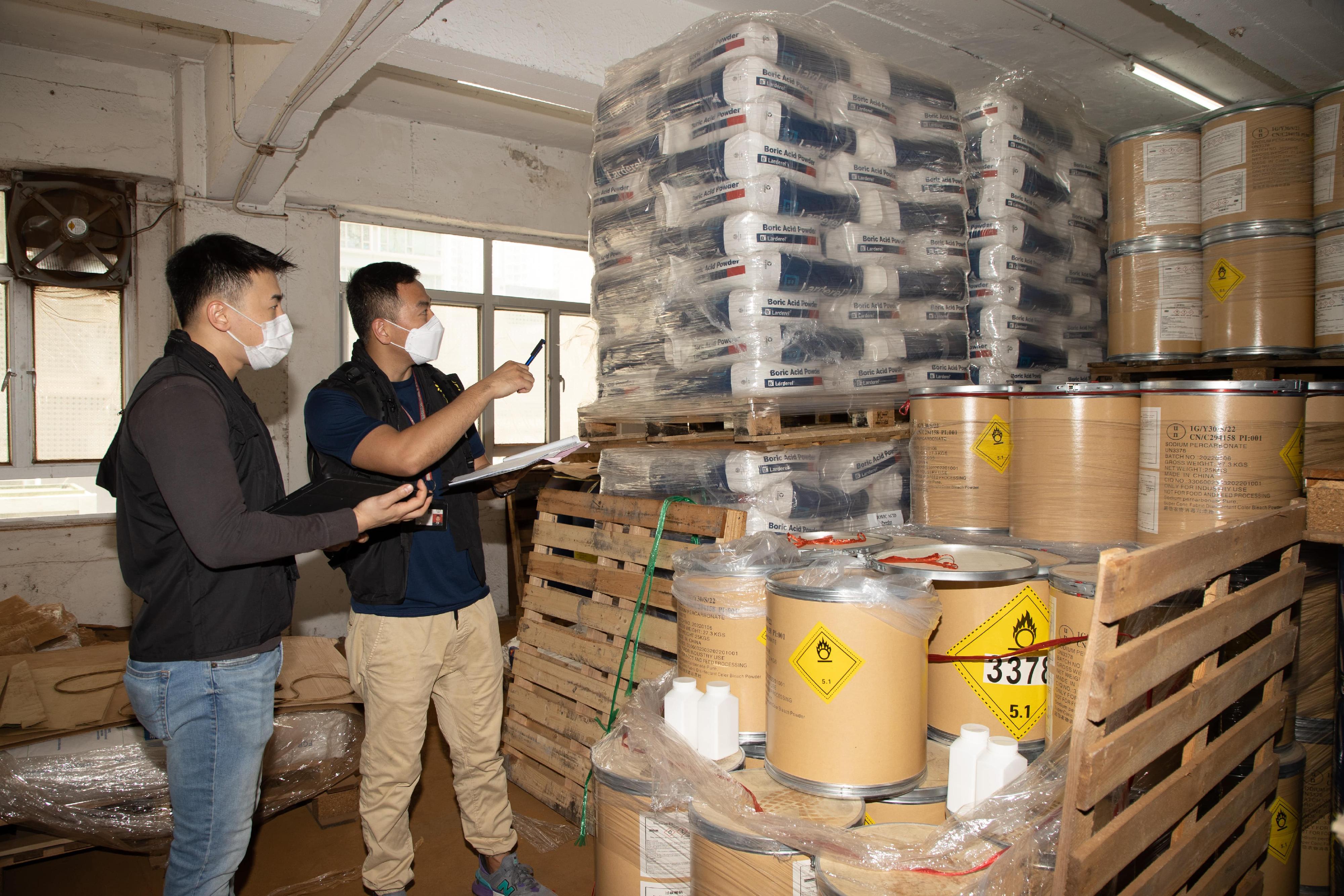The Fire Services Department mounted a territory-wide enforcement operation codenamed "Crescent" in June. Photo shows law enforcement officers inspecting a premises suspected to be storing an excessive amount of dangerous goods.