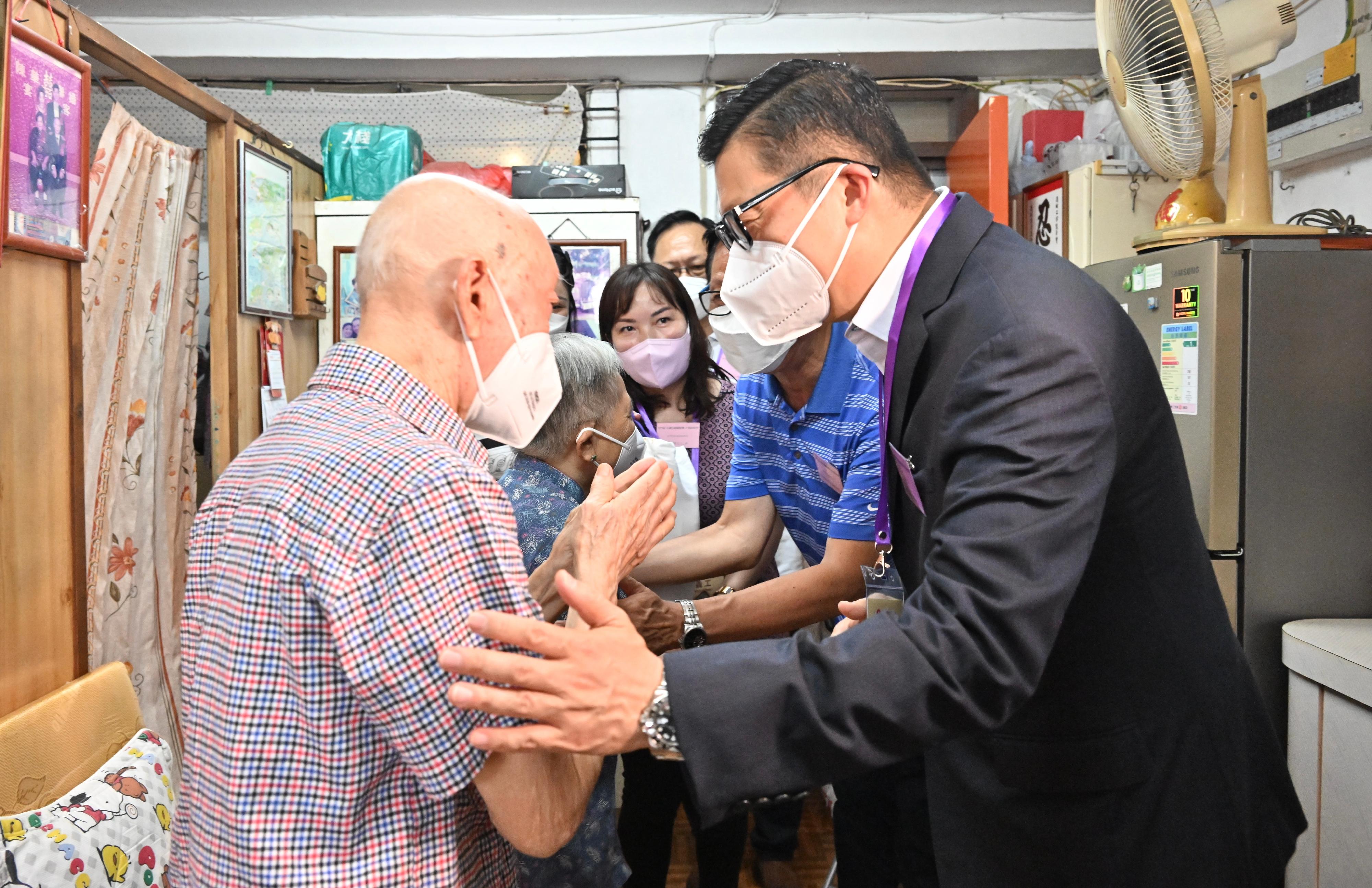 The Secretary for Security, Mr Tang Ping-keung, today (June 19) paid home visits under the Celebrations for All project in Tuen Mun District to show his care and concern for the grass-roots families, and distributed gift packs in celebration of the 25th anniversary of the establishment of the Hong Kong Special Administrative Region. Photo shows Mr Tang (first right) visiting an elderly doubleton household in Tai Hing Estate, learning more about their daily lives.